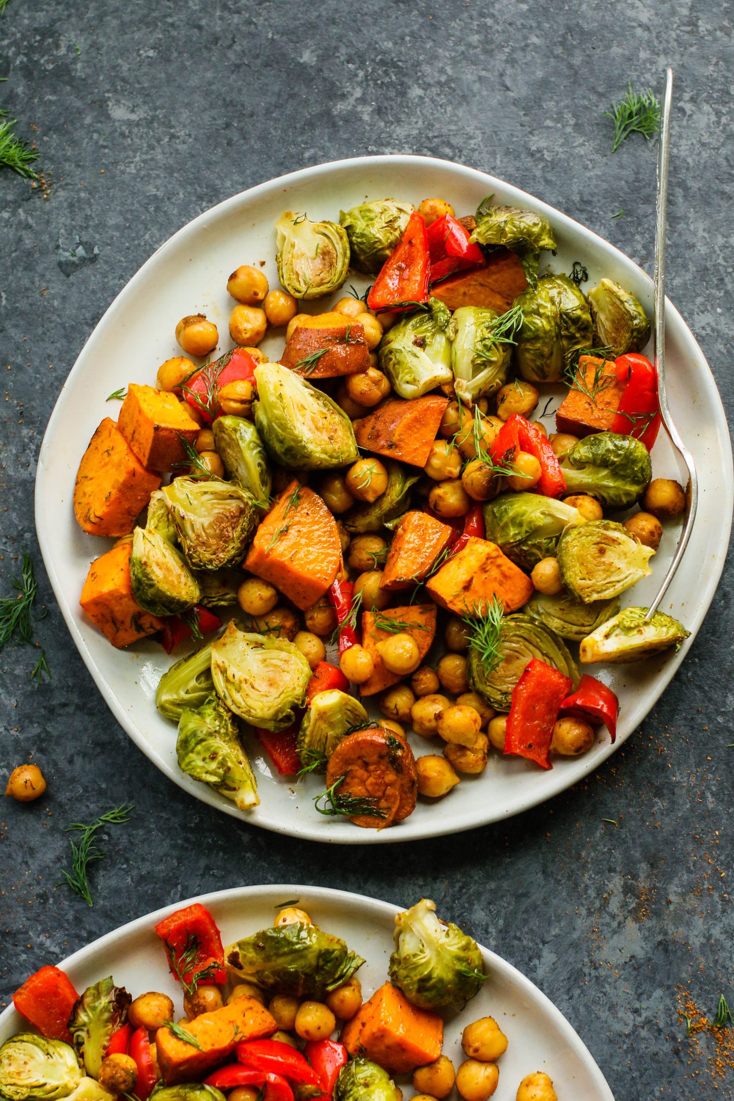 Sweet Potato & Chickpea Bake served on plates with forks and fresh dill by Flora & Vino