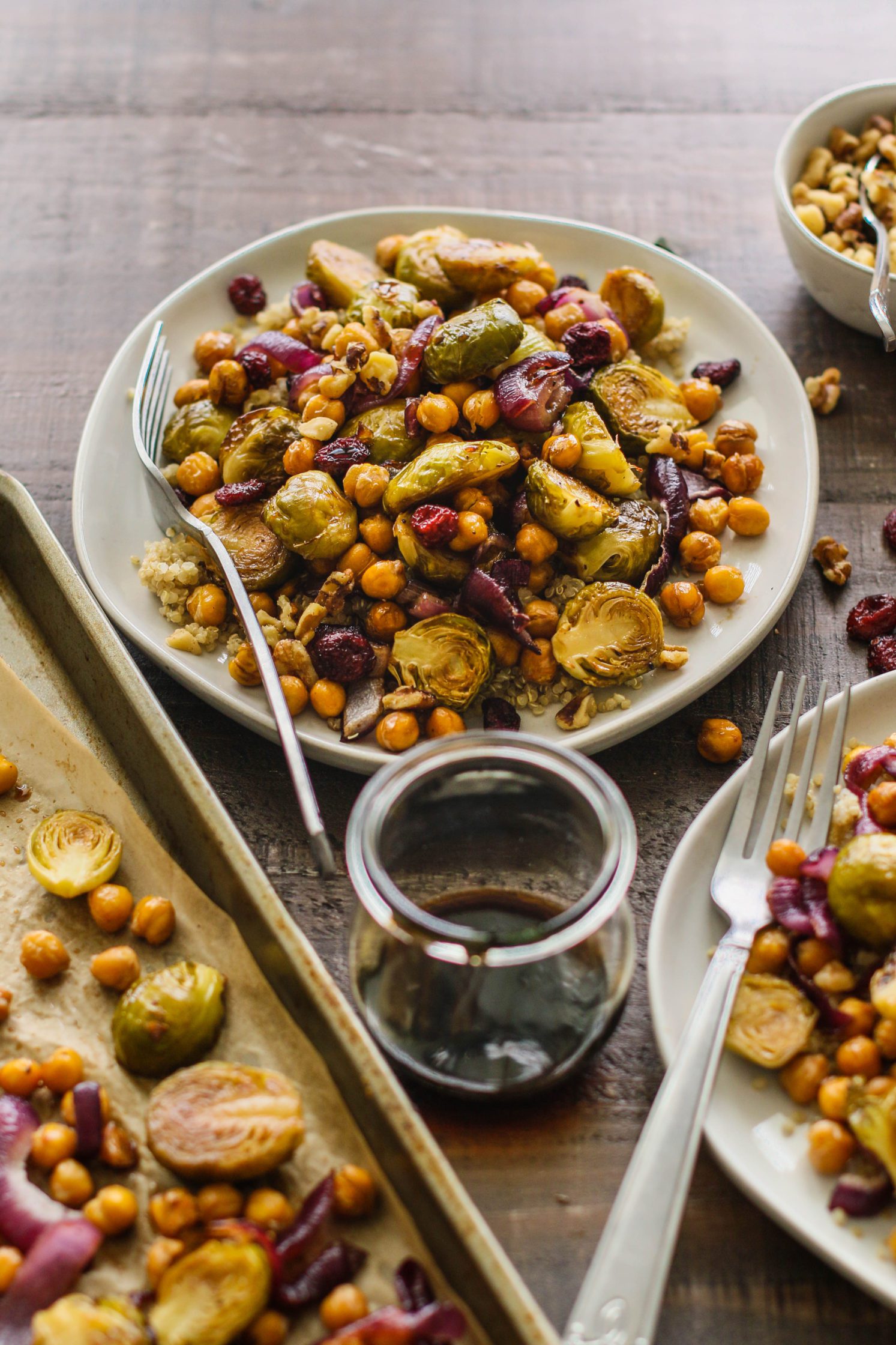 Maple Balsamic Brussels Sprouts & Chickpeas served on plates with forks by Flora & Vino