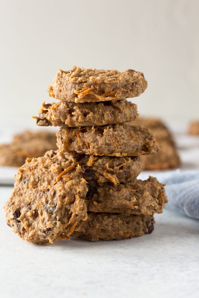 Quinoa Carrot Cake Breakfast Cookies stacked on board with blue towel