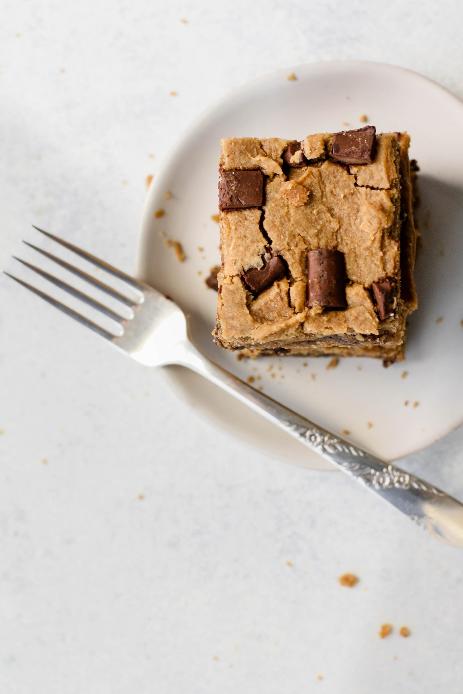 White Bean Blondies stacked on plate with fork by Flora & Vino