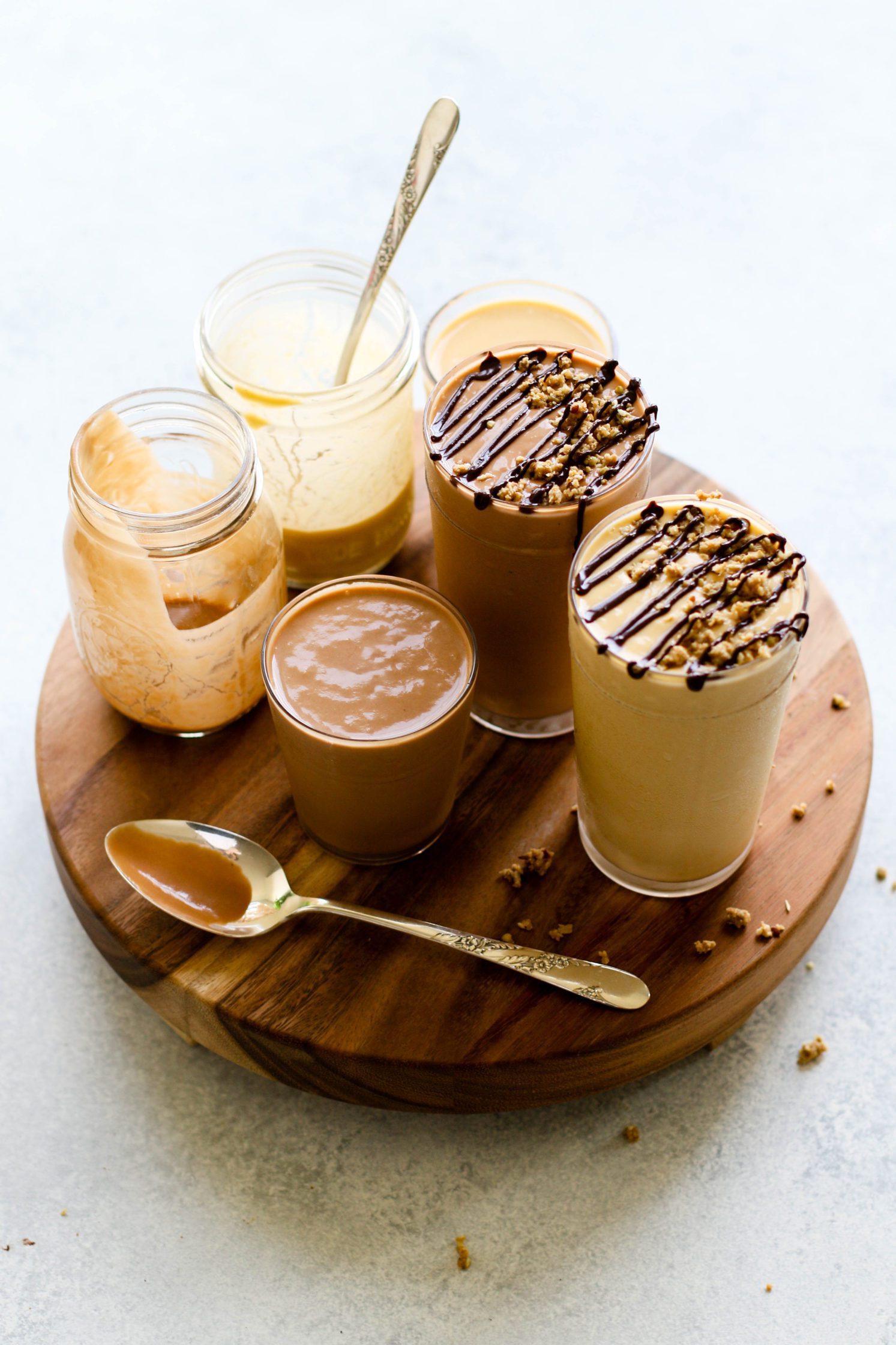 Fruit-Free "Fake Out" Shakes served in tall glasses topped with chocolate tahini and granola crumble by Flora & Vino