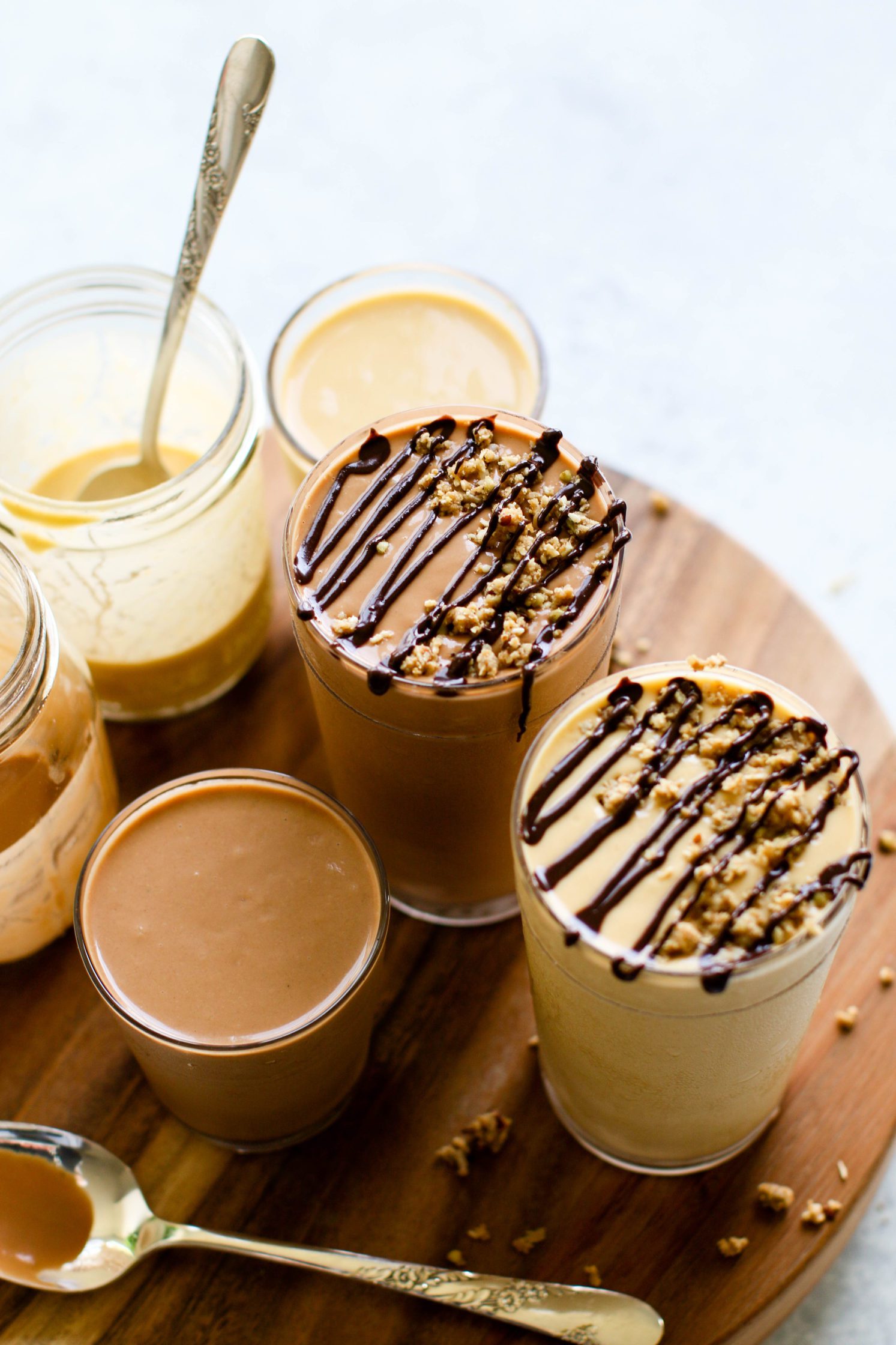 Fruit-Free "Fake Out" Shakes served in tall glasses topped with chocolate tahini and granola crumble by Flora & Vino