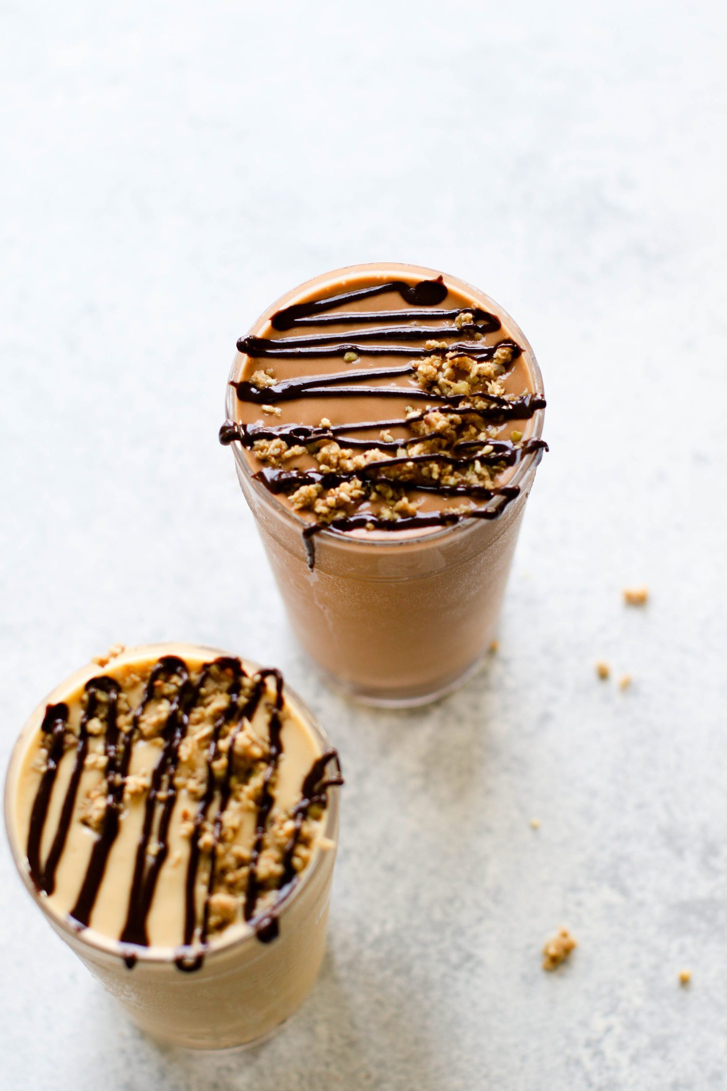 Fruit-Free "Fake Out" Shakes served in tall glasses topped with chocolate tahini and granola crumble by Flora & Vino