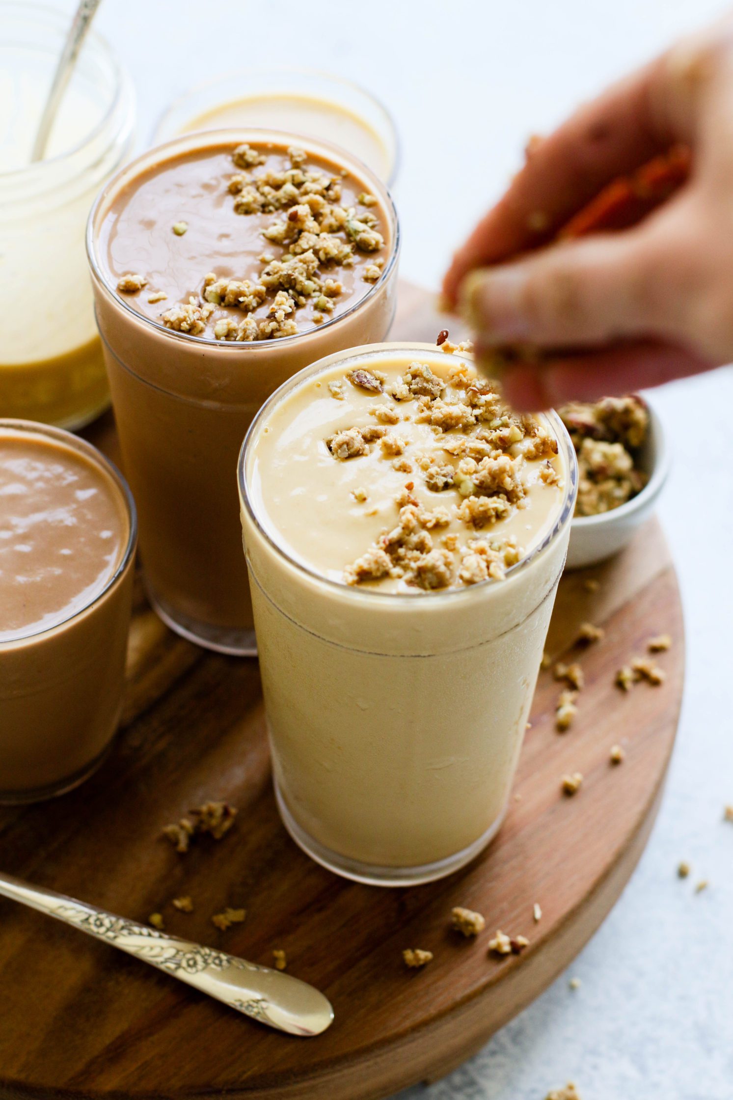 hand topping Fruit-Free "Fake Out" Shakes with granola by Flora & Vino