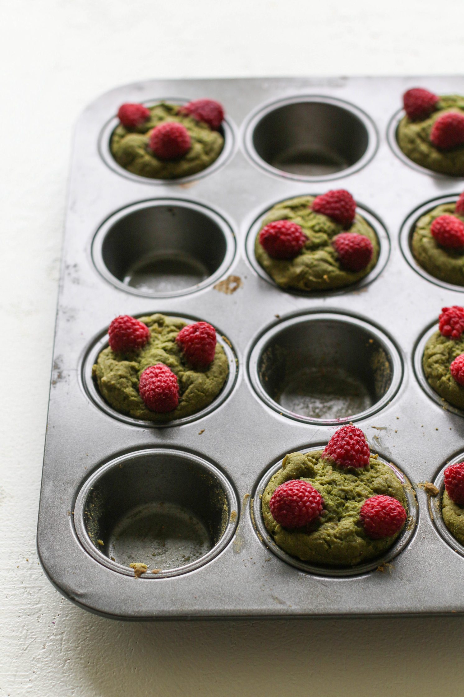 Raspberry Matcha Muffins in muffin tin by Flora & Vino