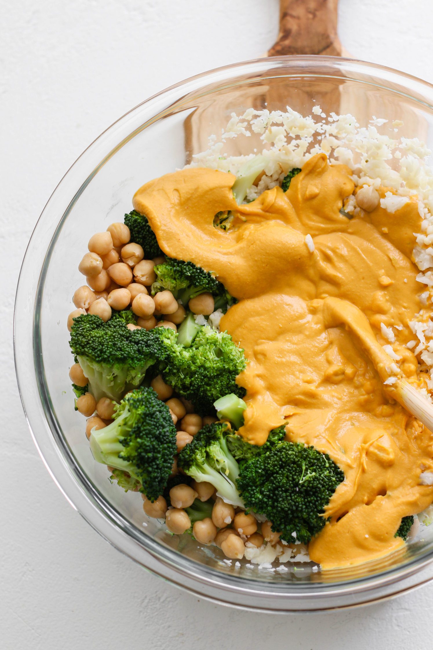 chickpeas, steamed broccoli, and cauliflower rice with cheese sauce in bowl by Flora & Vino