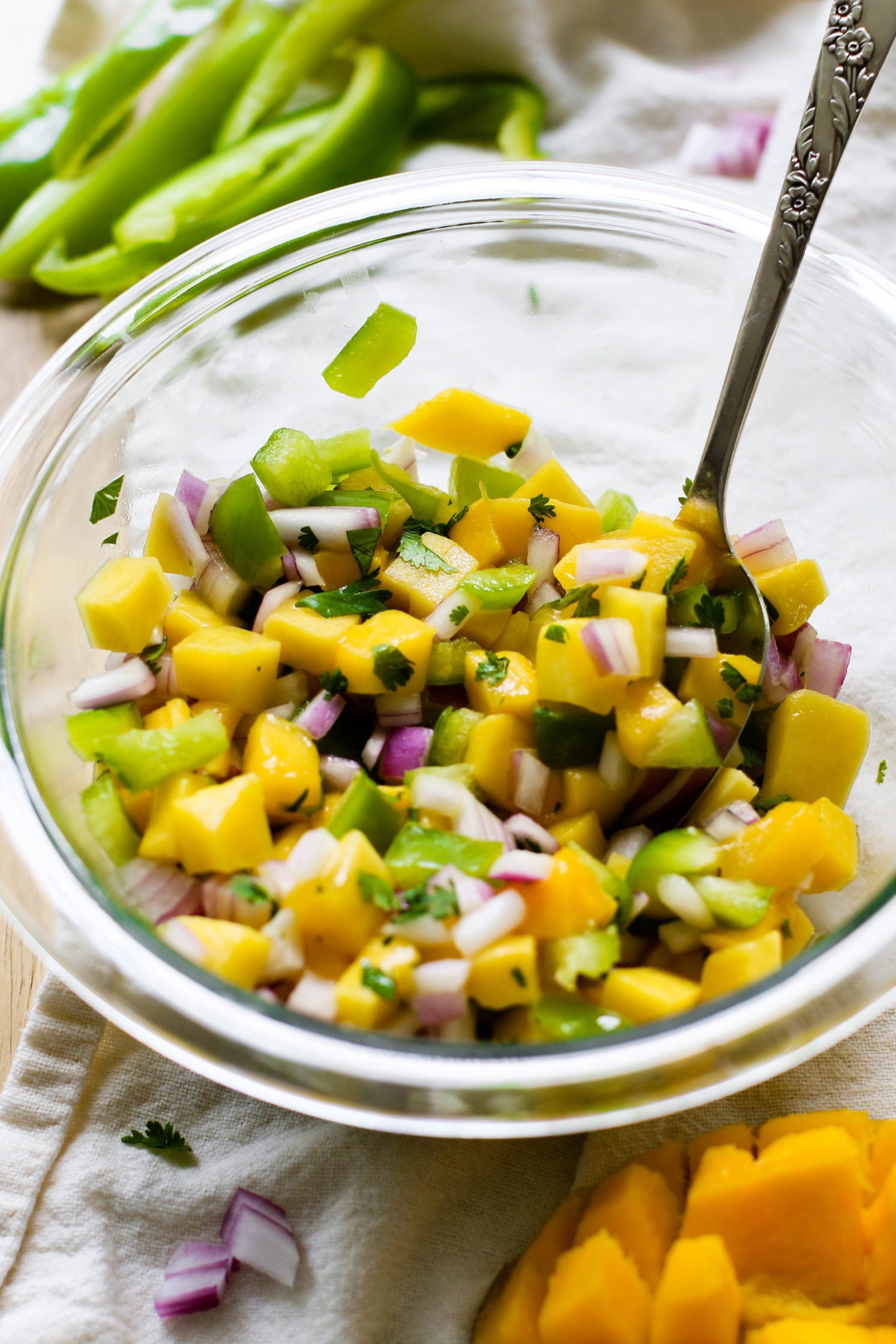 mango salsa served in bowl with spoon
