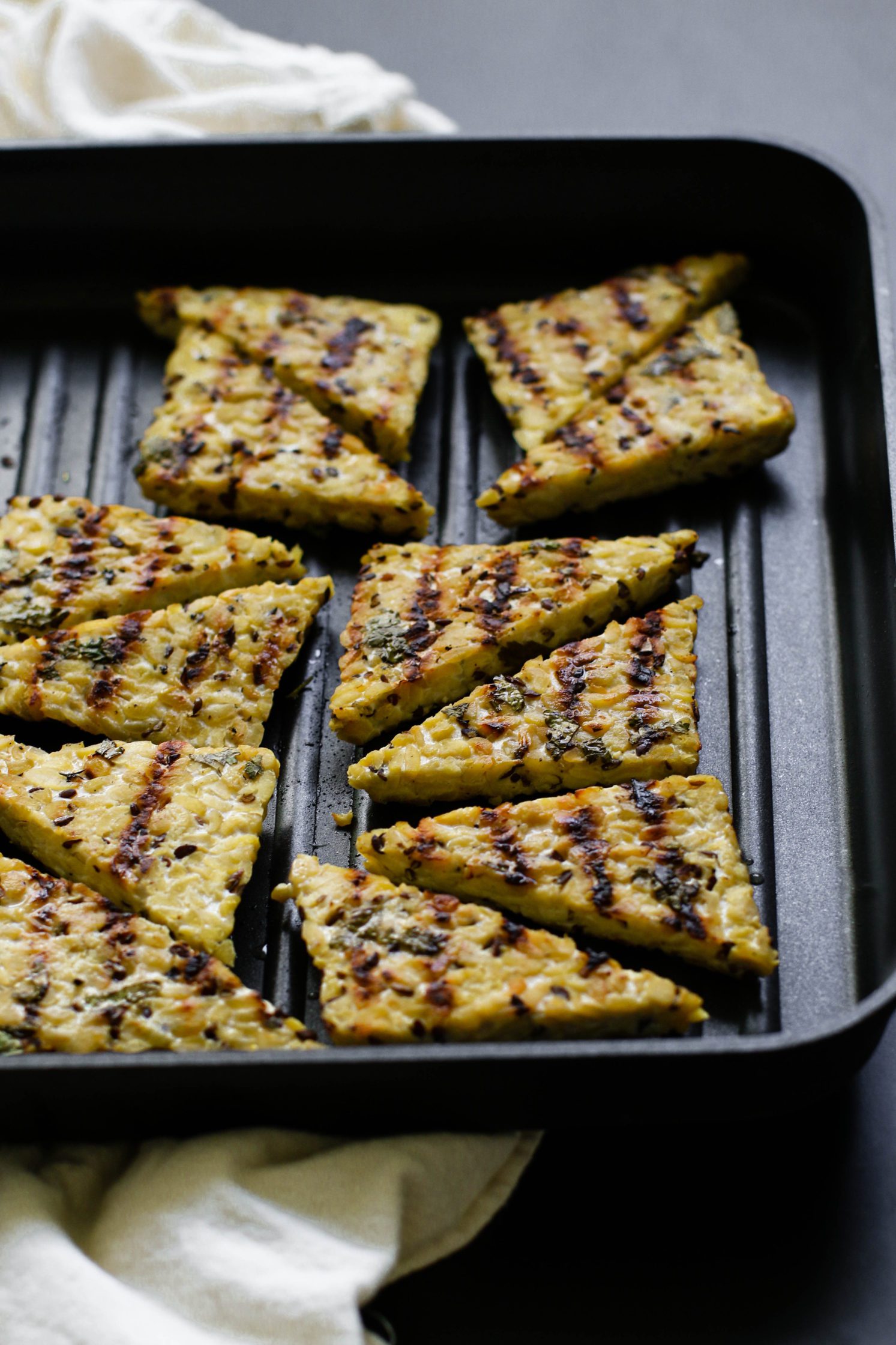 cilantro lime tempeh in triangles grilled on skillet