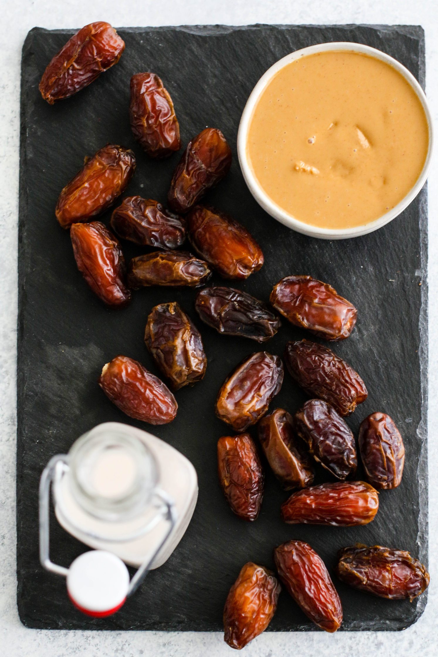 ingredients for Peanut Butter Date Caramel on black serving board