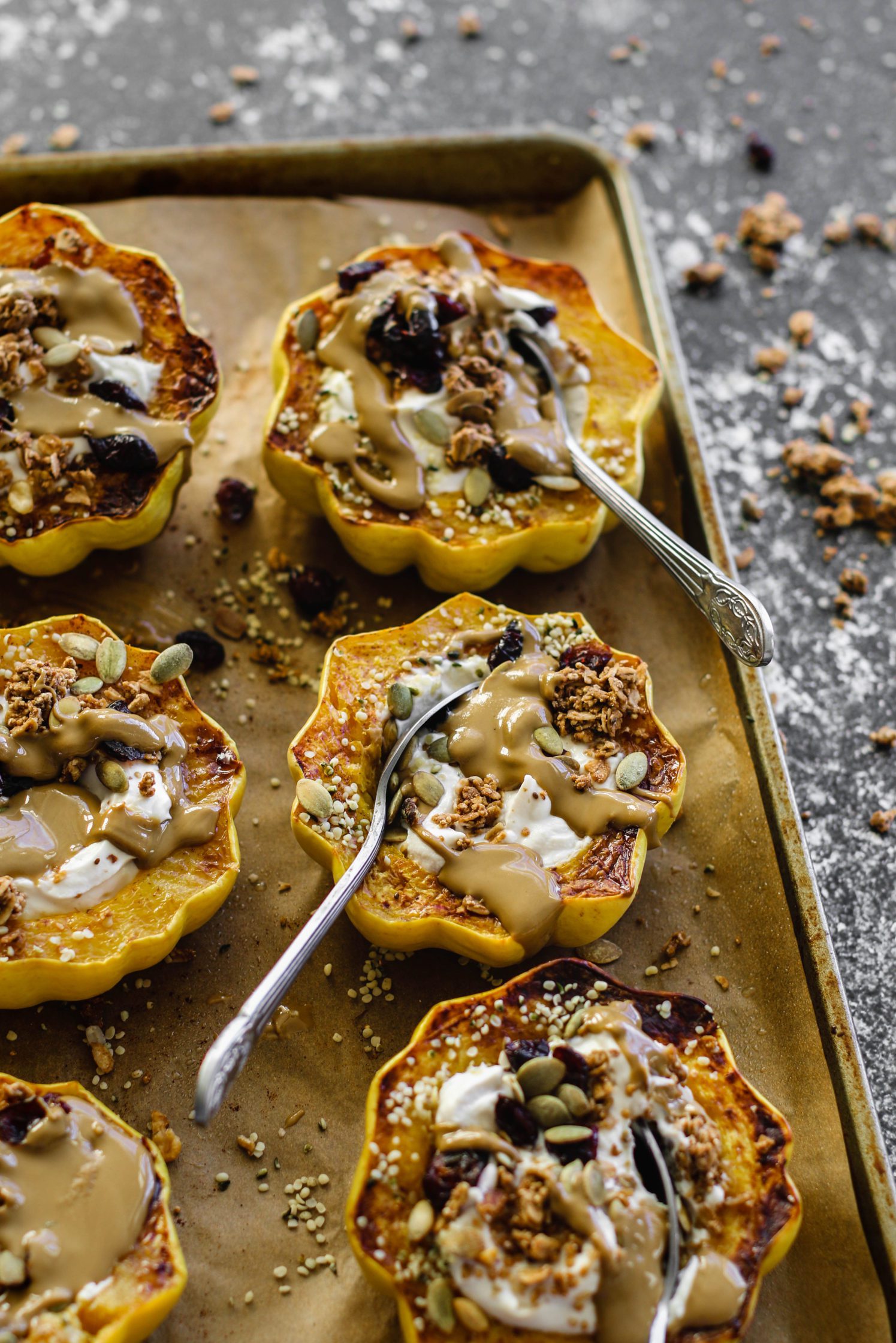 Breakfast Stuffed Squash on parchment lined baking sheet by Flora & Vino