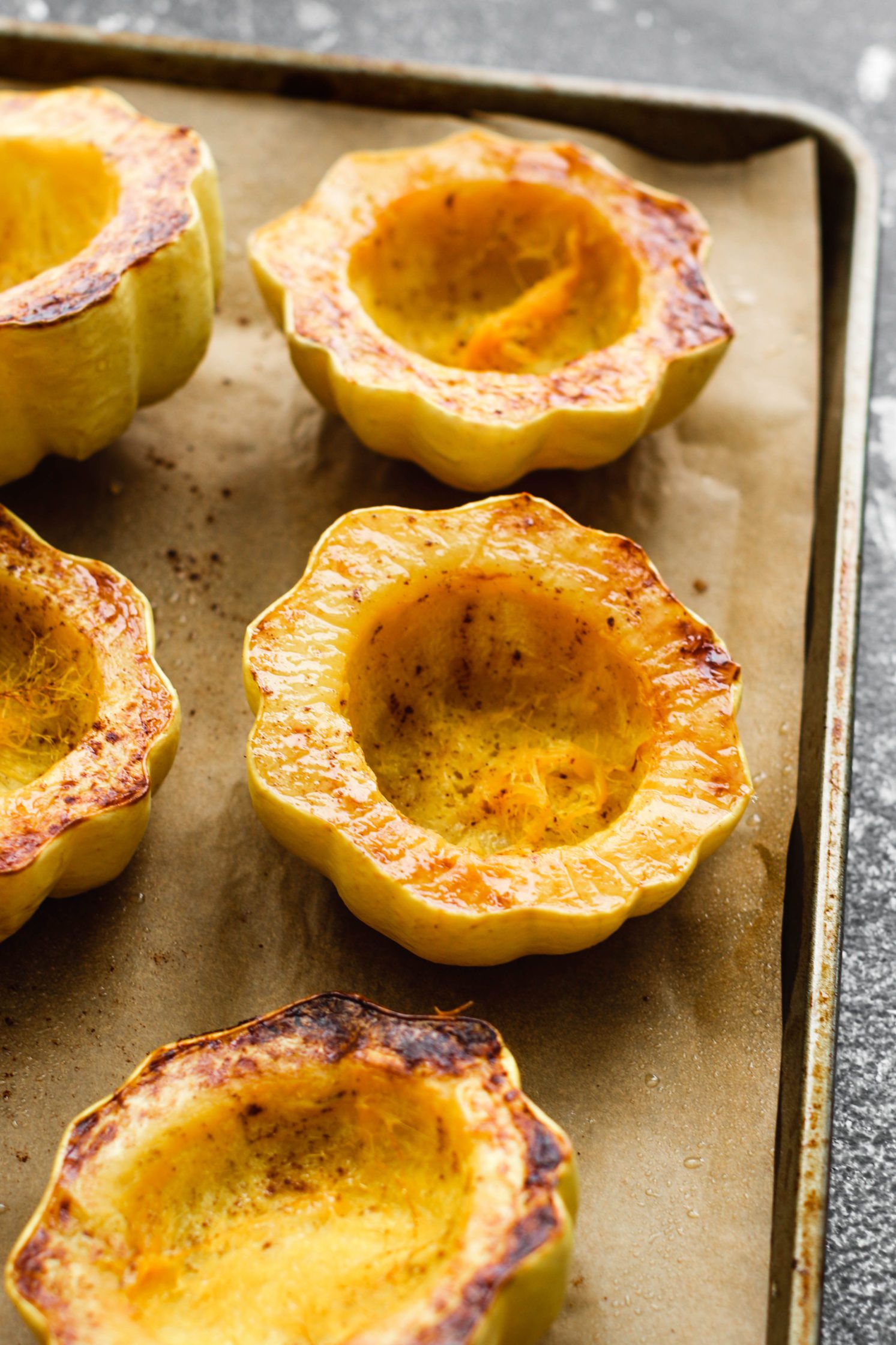 roasted carnival squash baked on parchment lined baking sheet by Flora & Vino