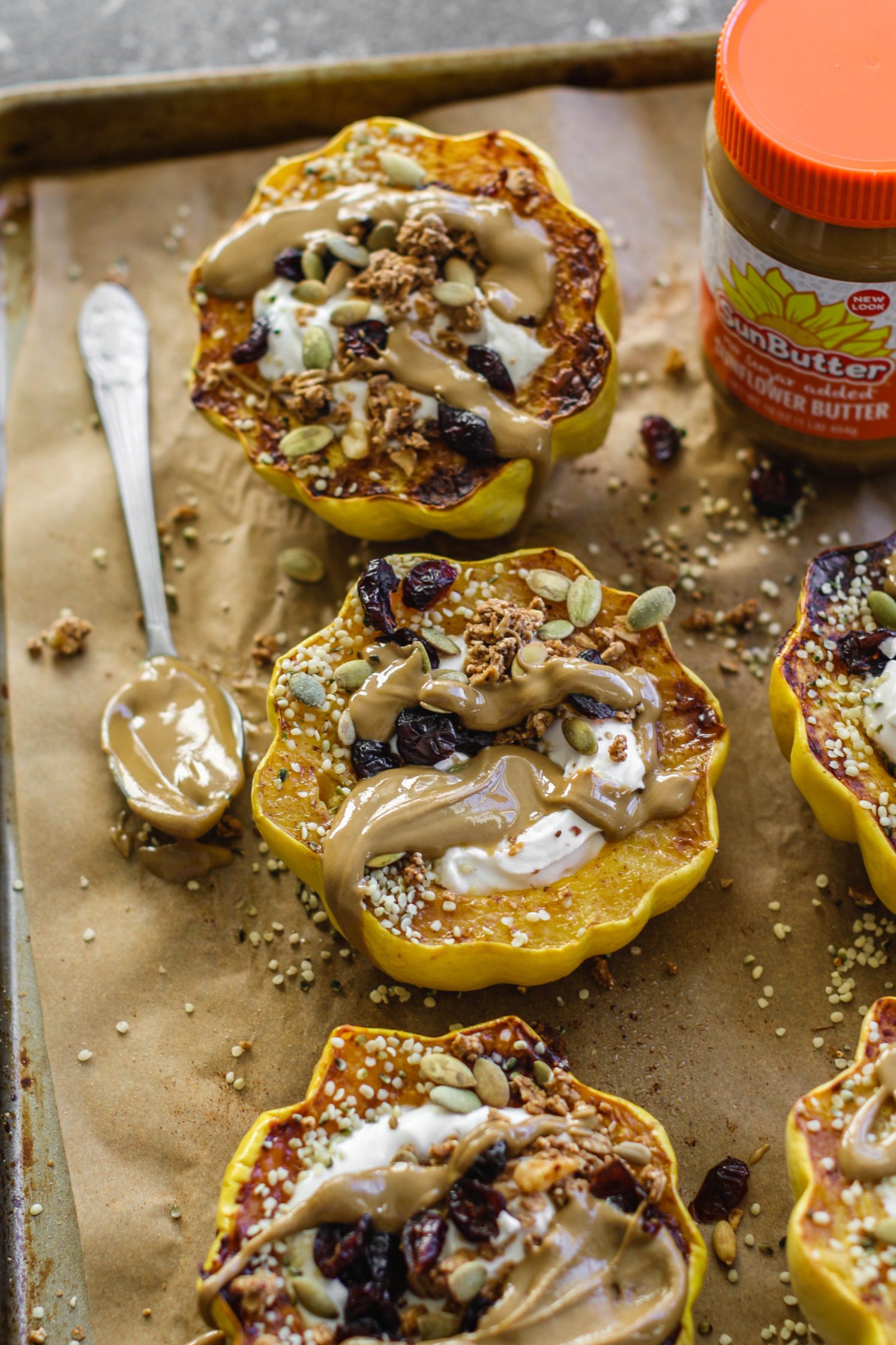 Breakfast Stuffed Squash on parchment lined baking sheet by Flora & Vino