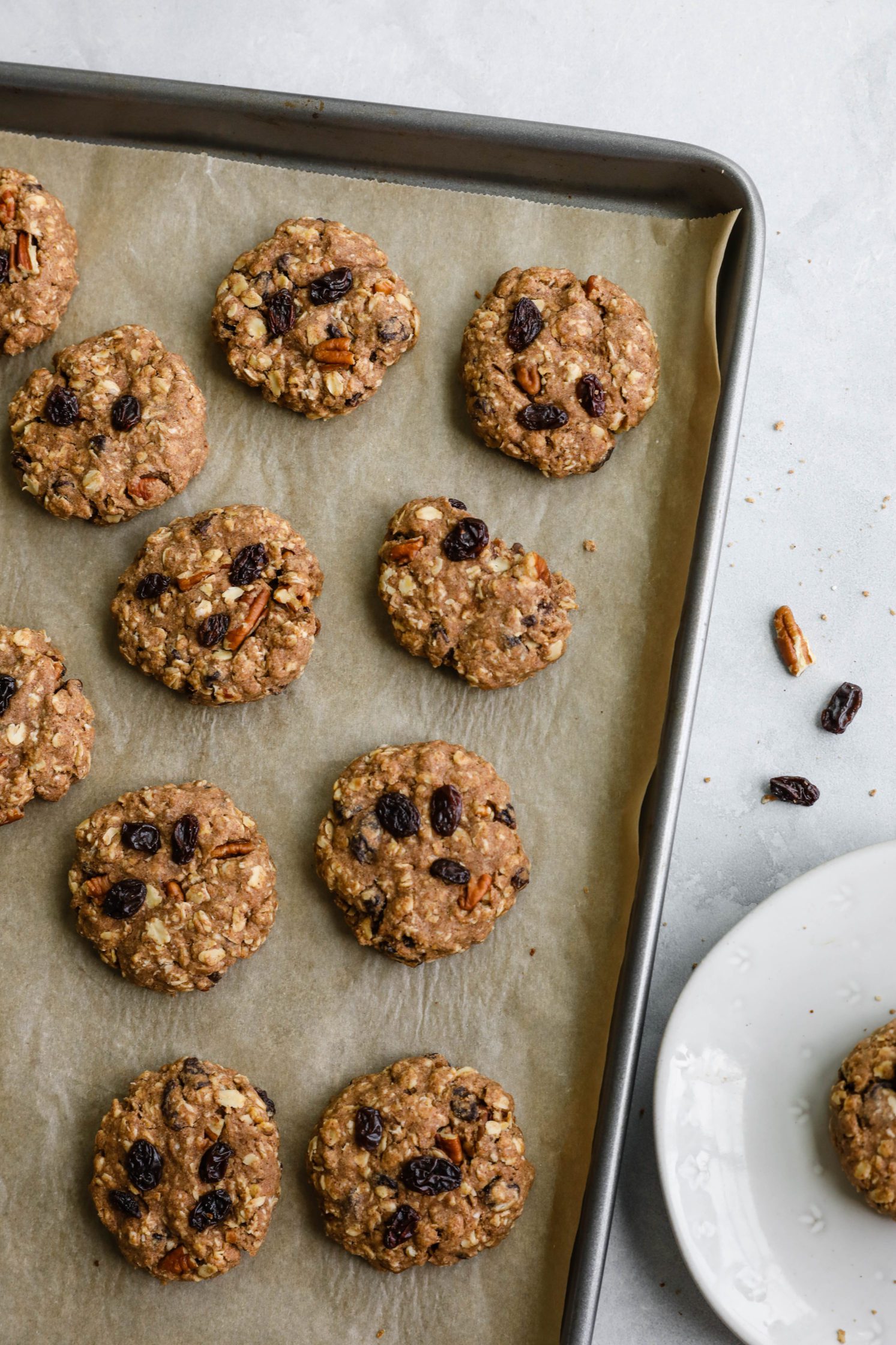 Oatmeal Raisin Pecan Cookies baked on parchment lined baking sheet by Flora & Vino