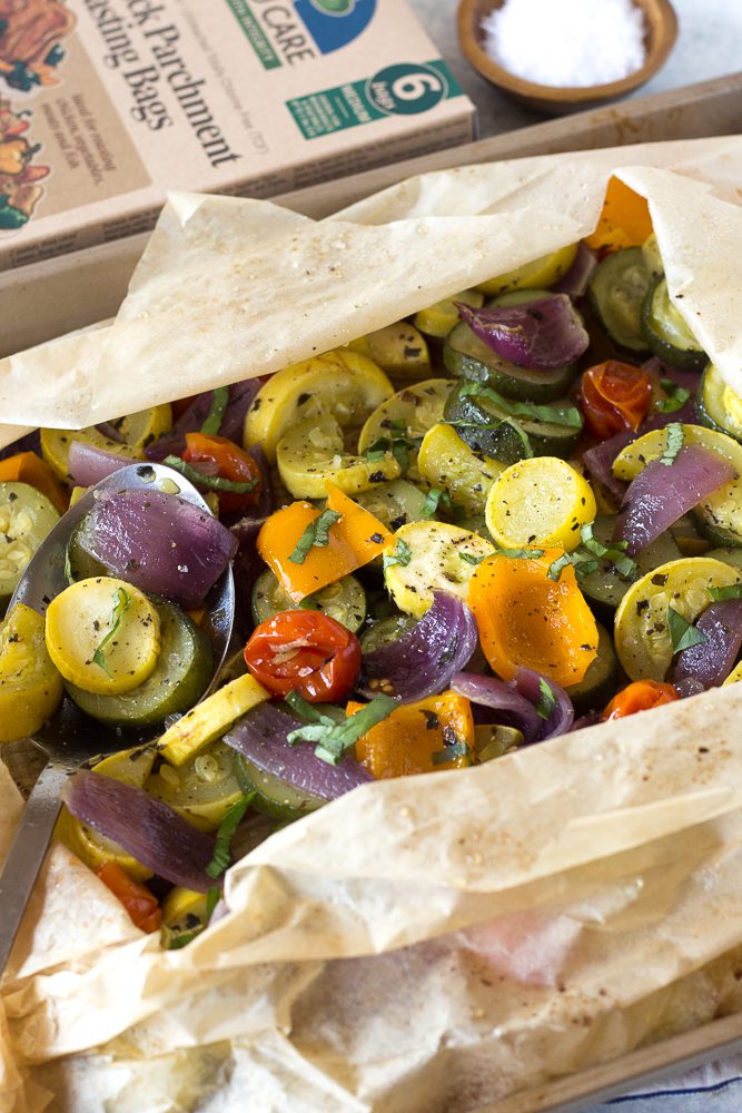 Oven Roasted Summer Vegetables in parchment paper roasting bag topped with fresh herbs