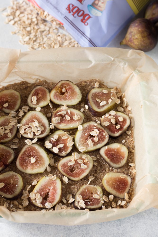 Fig Newton Breakfast Bars uncooked in parchment lined baking pan by Flora & Vino