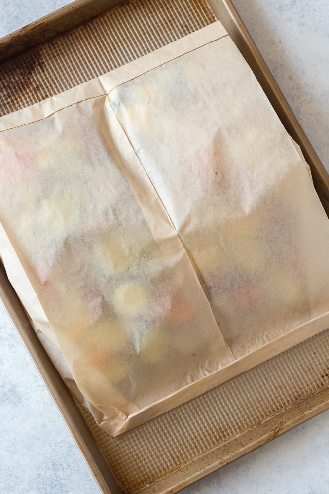 Oven Roasted Summer Vegetables in parchment paper roasting bag on baking dish