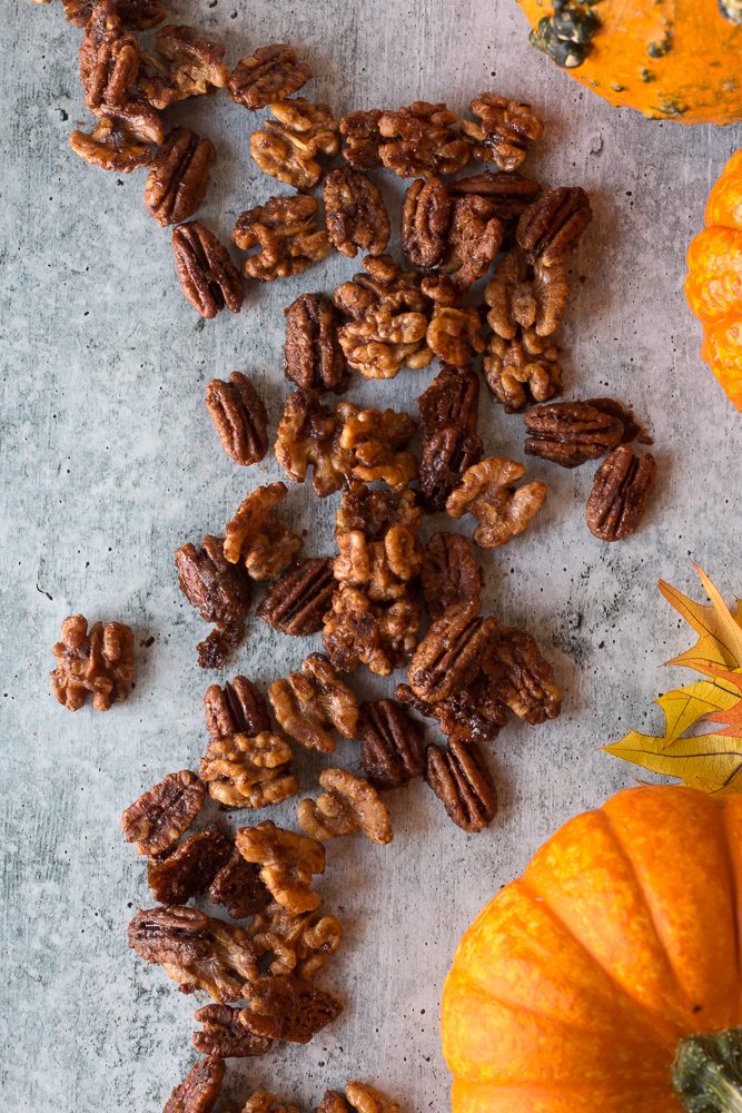 Easy Maple Spiced Nuts on board surrounded by pumpkins by Flora & Vino