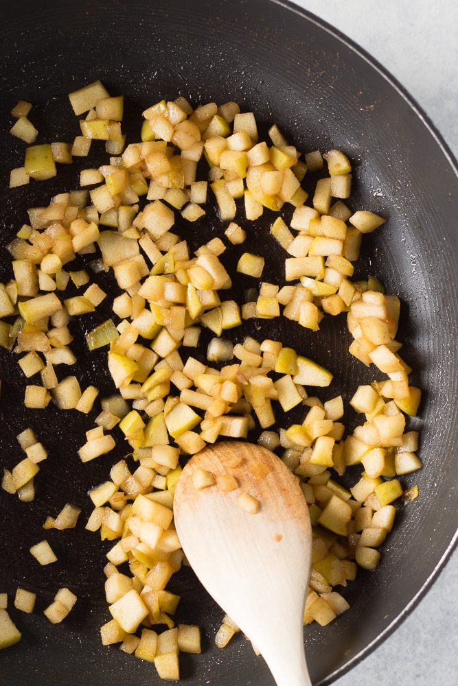sautéed apples in pan with wooden spoon by Flora & Vino