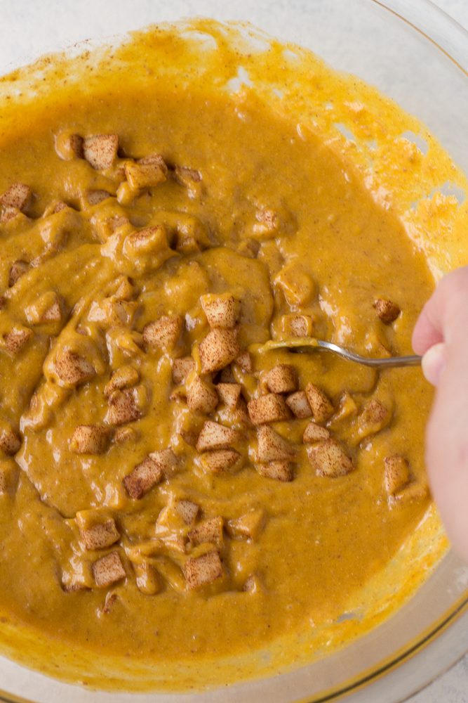 mixing cinnamon apples in pumpkin apple puree
