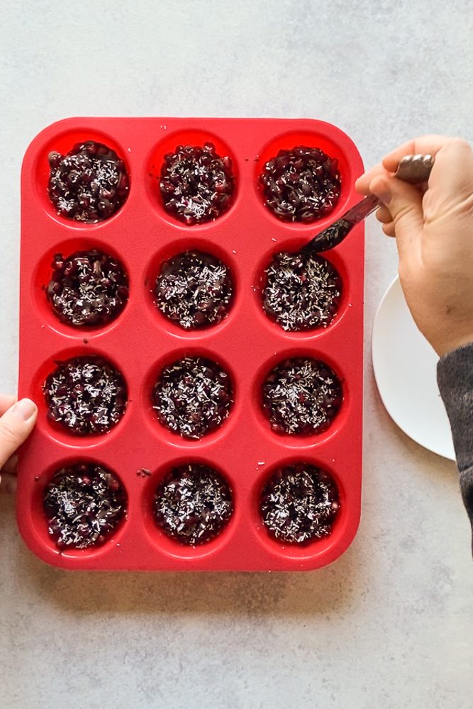 using knife to extract chocolate covered pomegranate cups by Flora & Vino