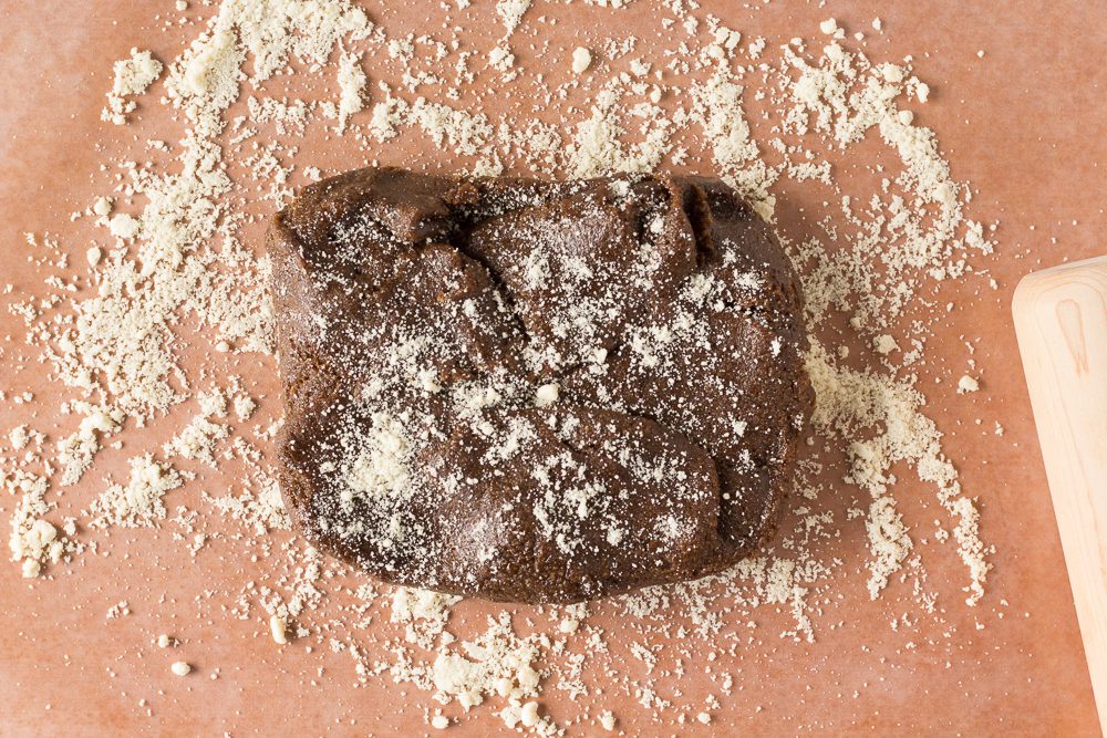 Gingerbread Cookies dough spread on counter with flour by Flora & Vino 