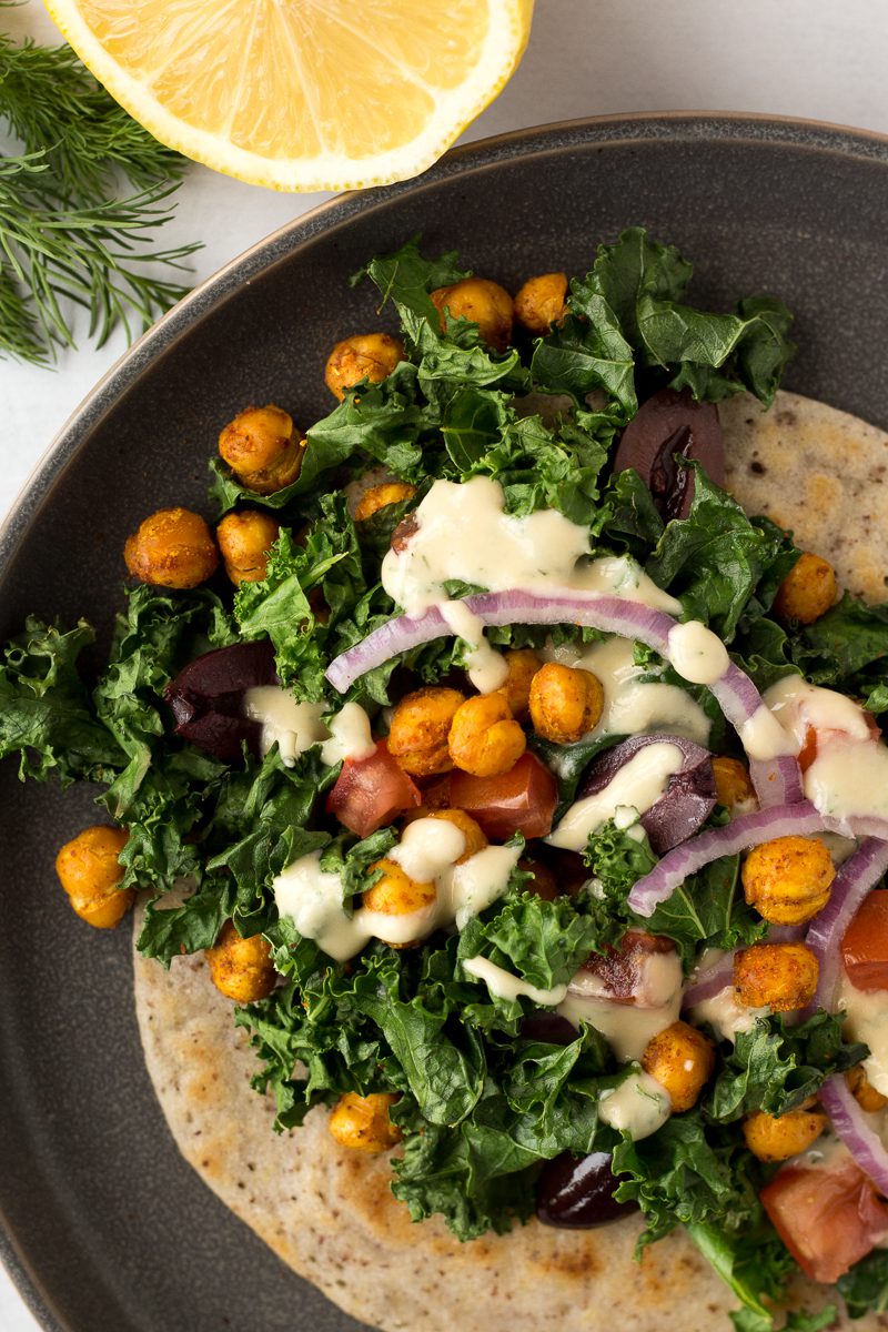 Grain-Free Flatbread Wraps served on plate with baked kale, chickpeas, red onion, and dill hummus sauce