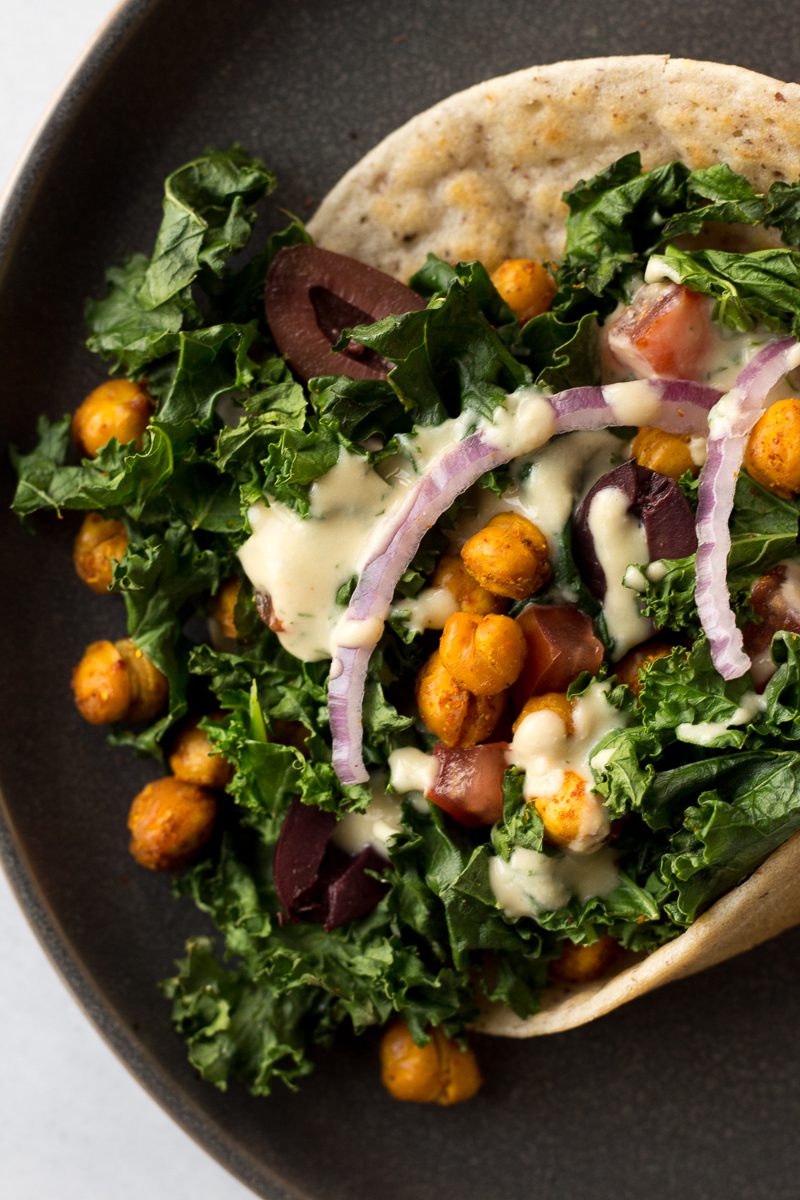 Grain-Free Flatbread Wraps served on plate with baked kale, chickpeas, red onion, and dill hummus sauce