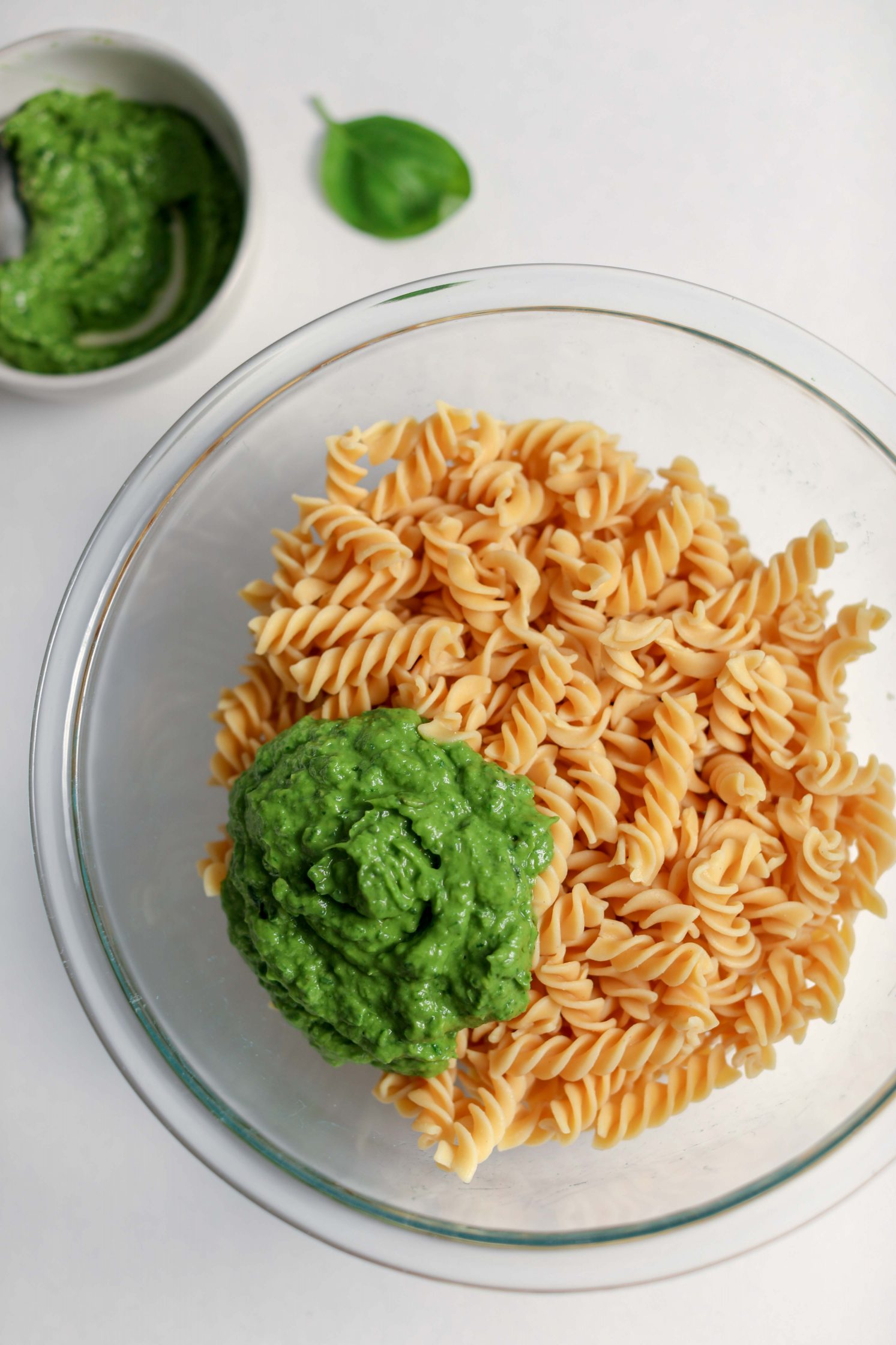 Avocado Collard Greens Pesto on top of cooked noodles in bowl