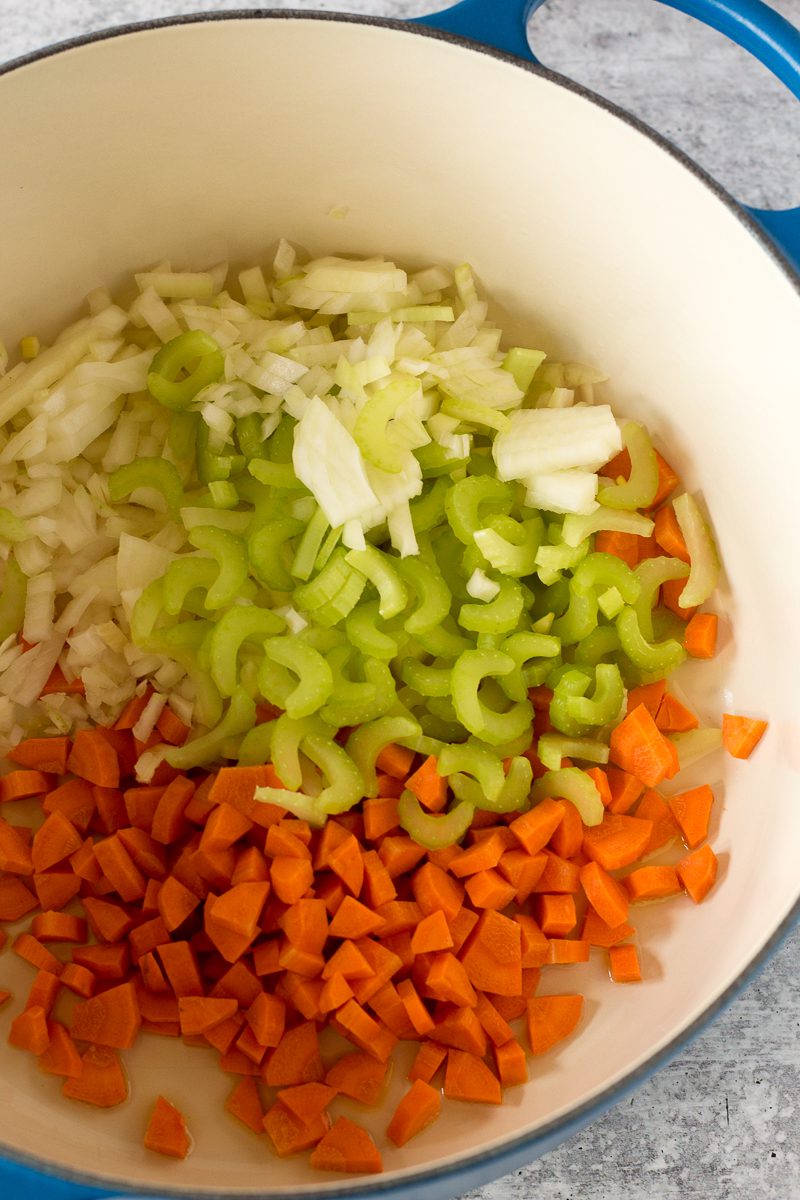 carrots, celery, and onion in pot by Flora & Vino