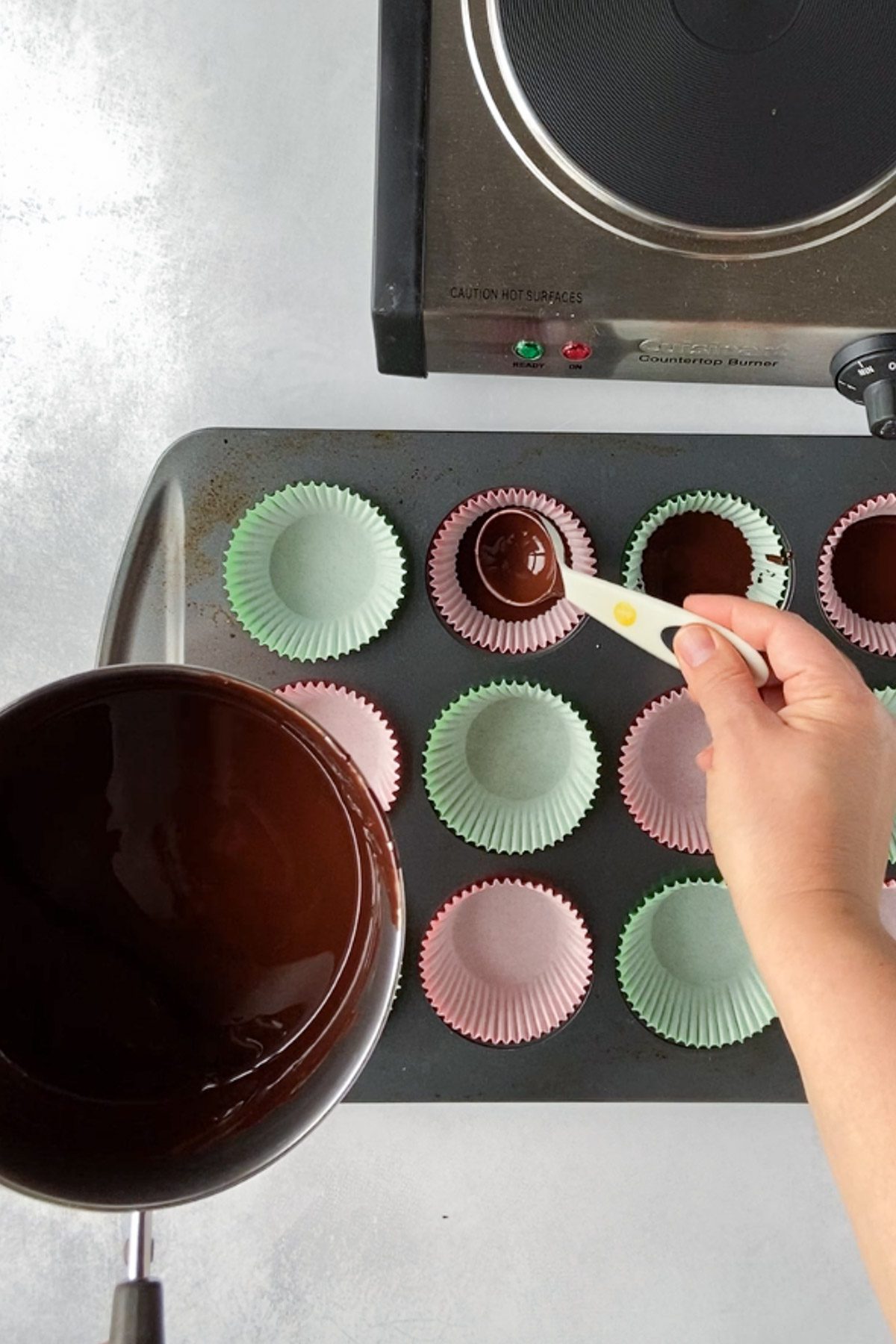 pouring chocolate into muffin tins by Flora & Vino