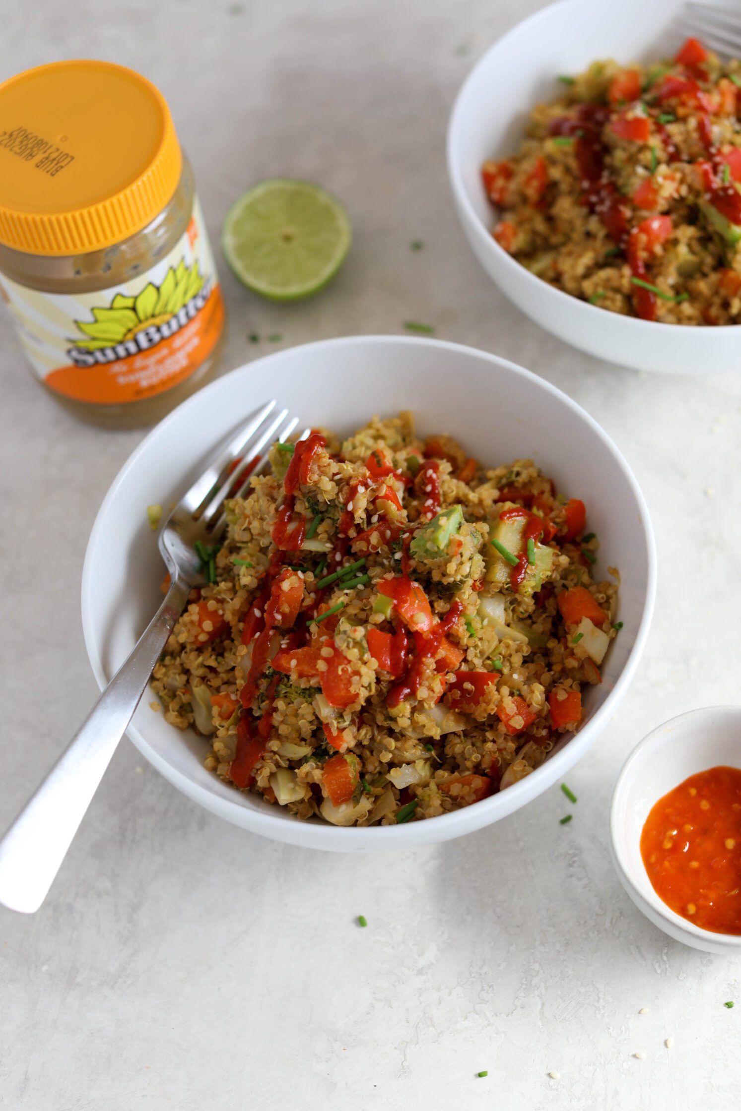 SunButter Quinoa Fried Rice served in bowls with a fork by Flora & Vino