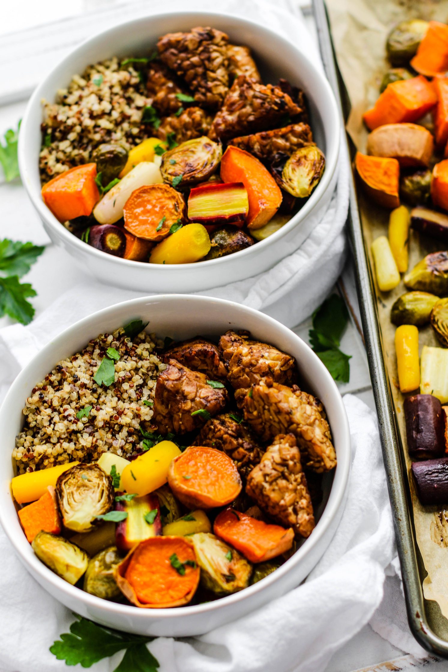 Maple Balsamic Tempeh Bowls served in bowls with sheet pan on the side