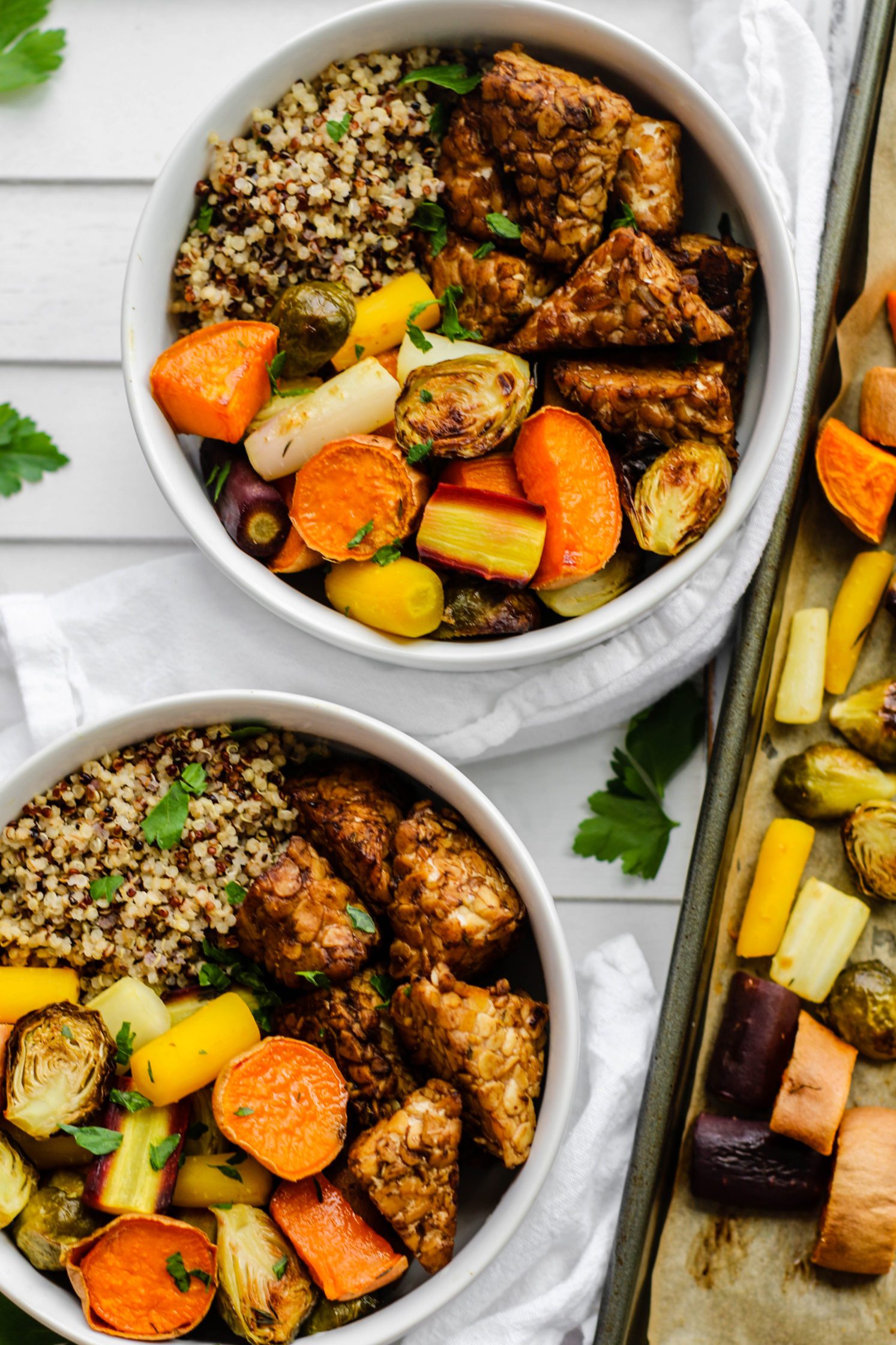 Maple Balsamic Tempeh Bowls served in bowls with rainbow vegetables with sheet pan on side