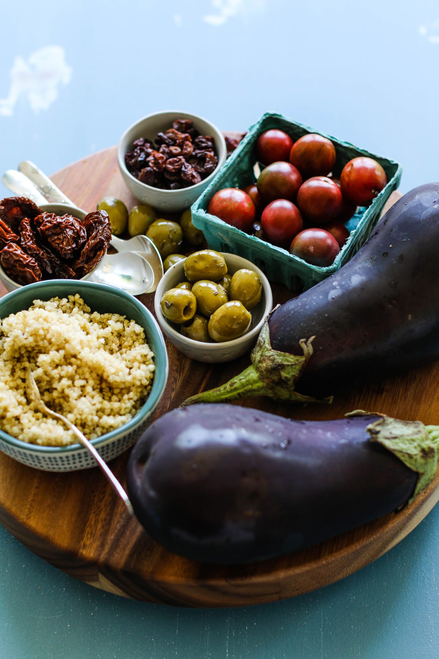 Quinoa Stuffed Eggplant ingredients on wooden board by Flora & Vino