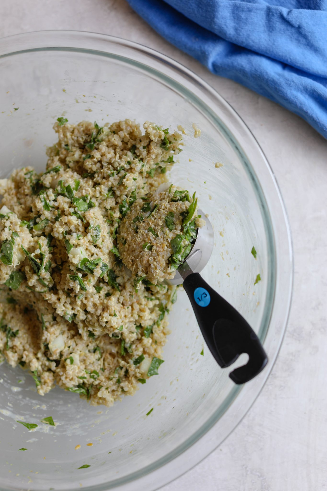 Quinoa Cakes mixed in bowl with measuring cup by Flora & Vino