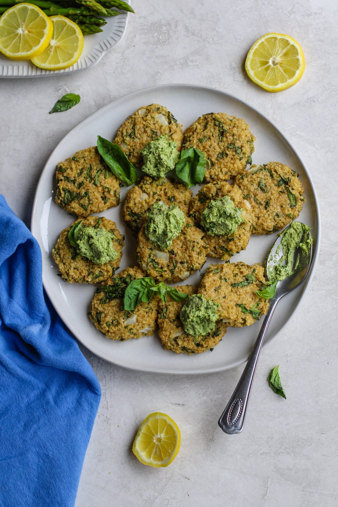 Quinoa Cakes served on plate dollops of basil pesto by Flora & Vino