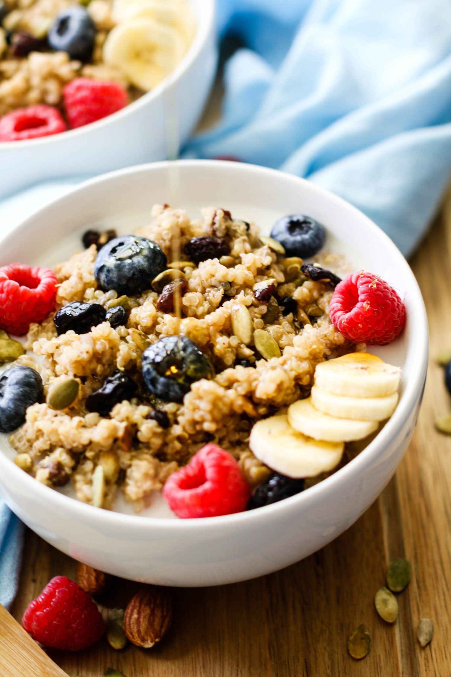 syrup poured on warm leftover quinoa breakfast bowls