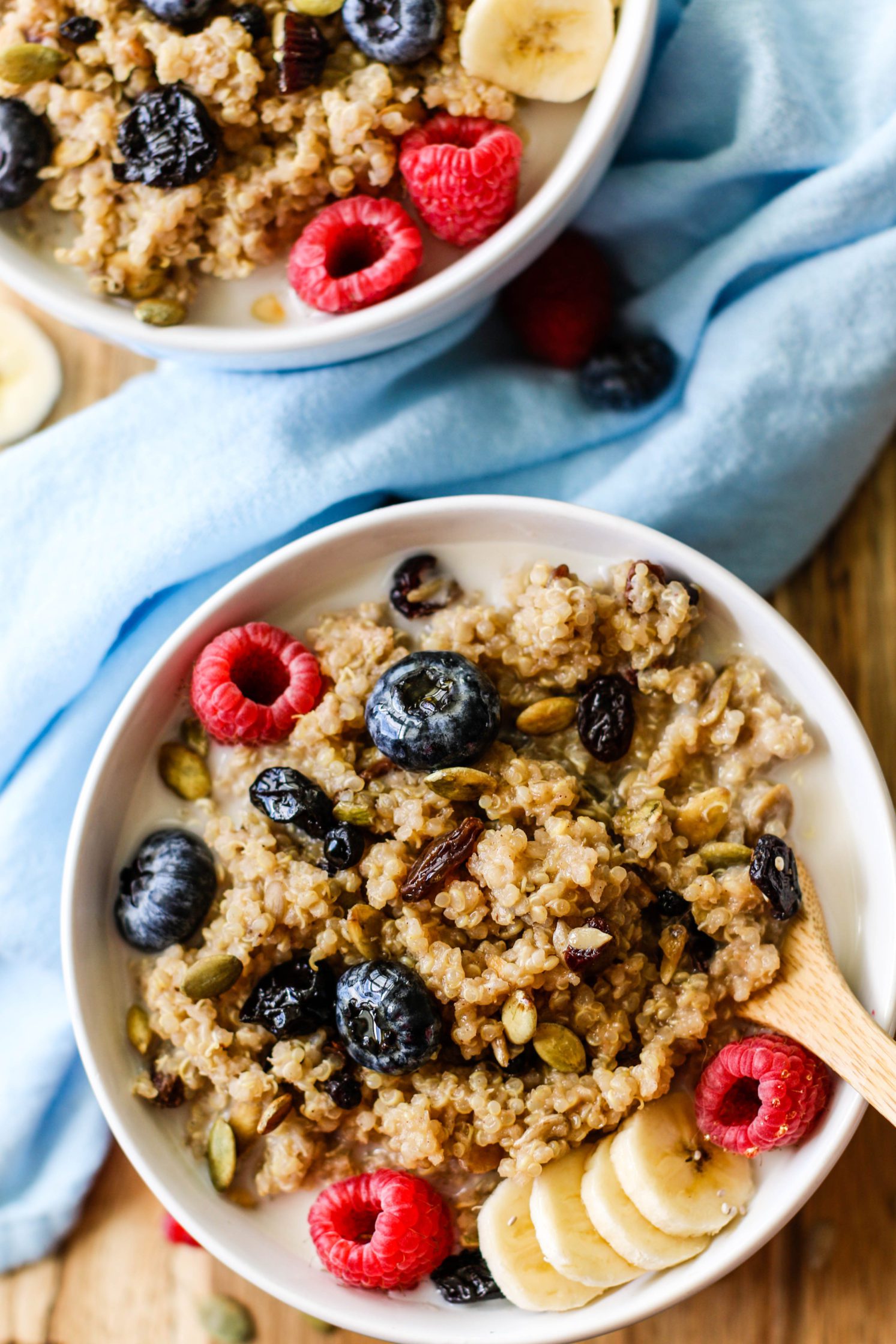 Leftover Quinoa Breakfast Bowls served on wooden board with a blue towel