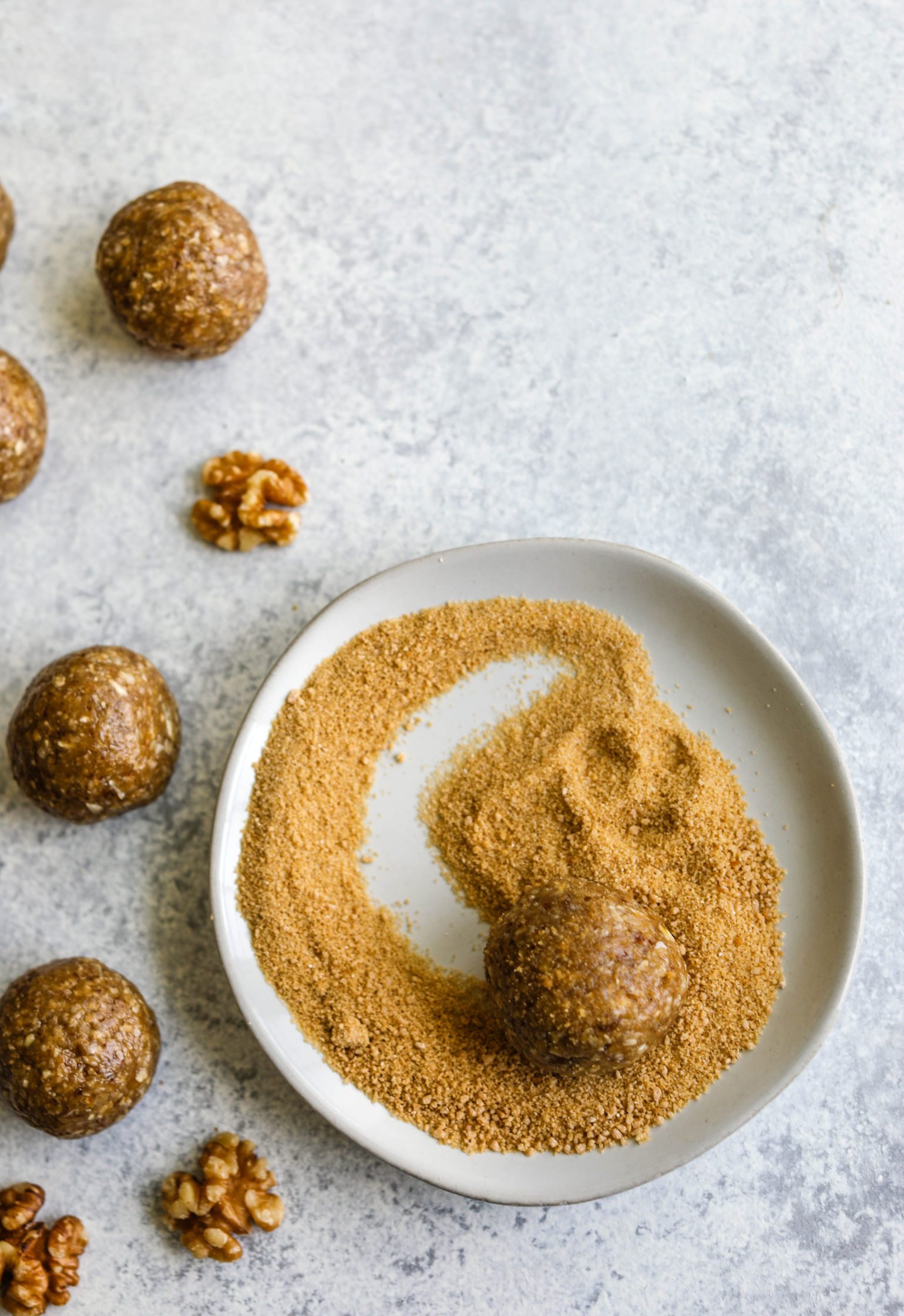Maple Walnut Bliss Balls rolled in maple sugar on white plate