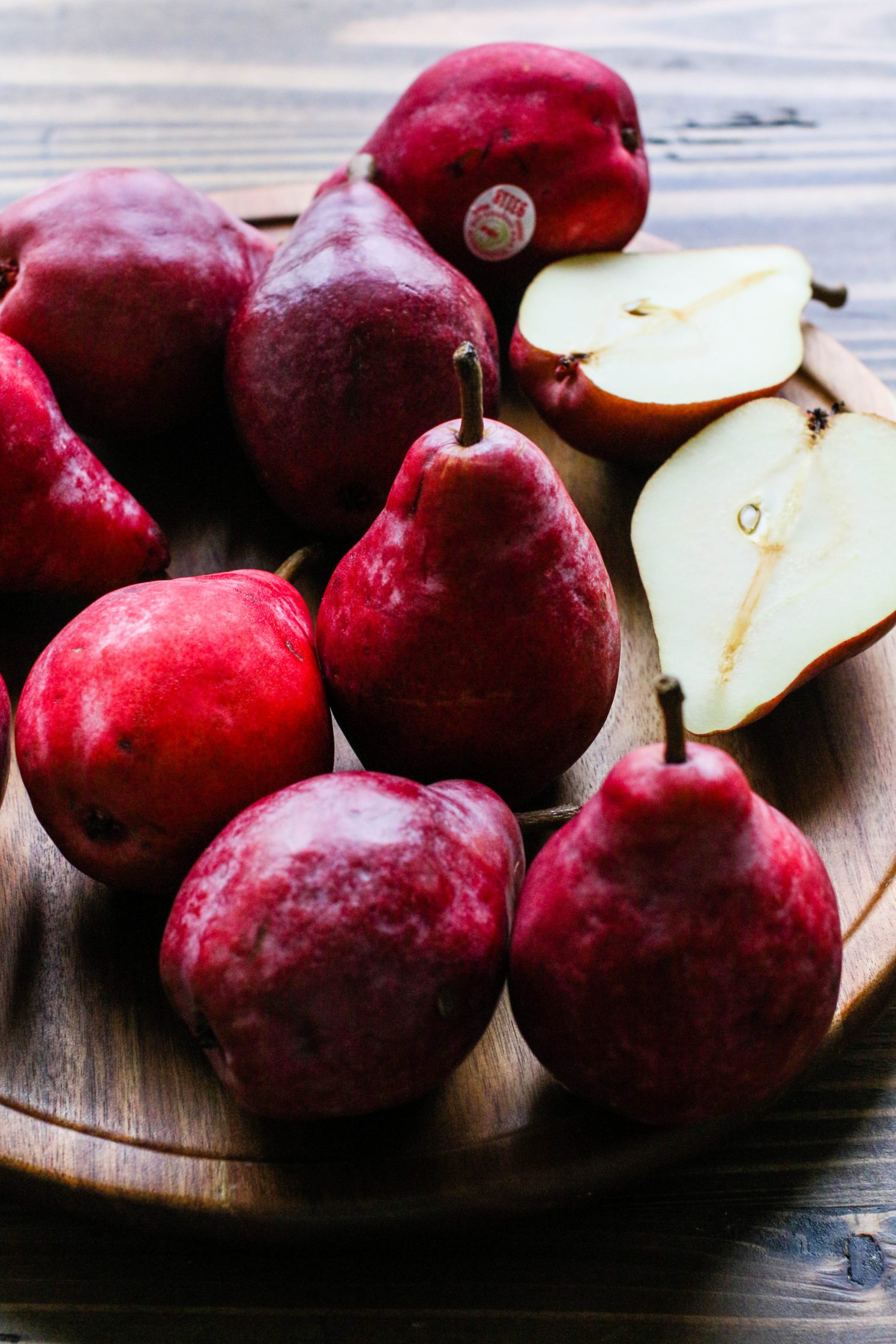 pears sliced on wooden board by Flora & Vino