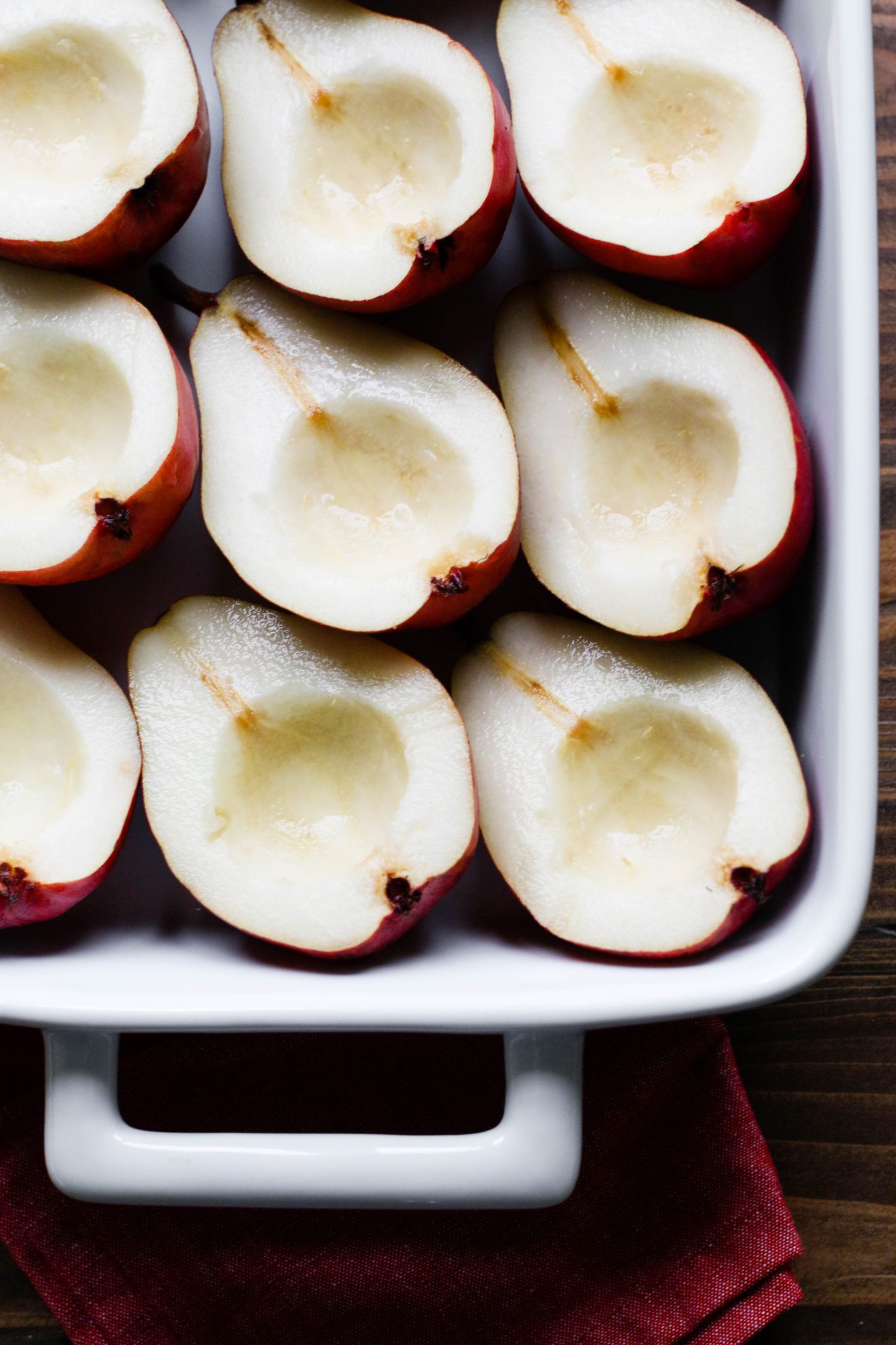 pears halved in baking dish by Flora & Vino