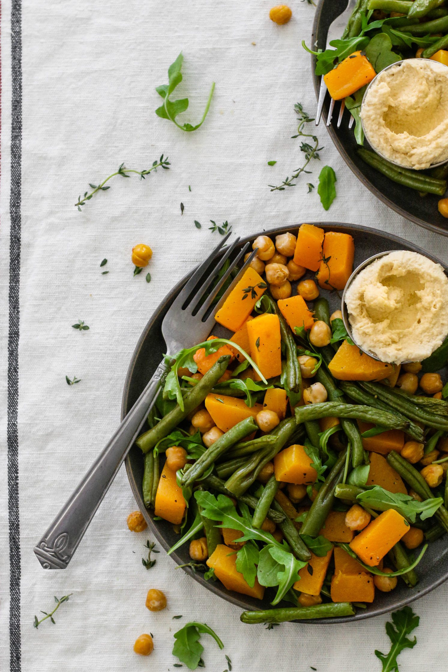 Butternut Squash & Chickpea Bake served on plates with a fork by Flora & Vino