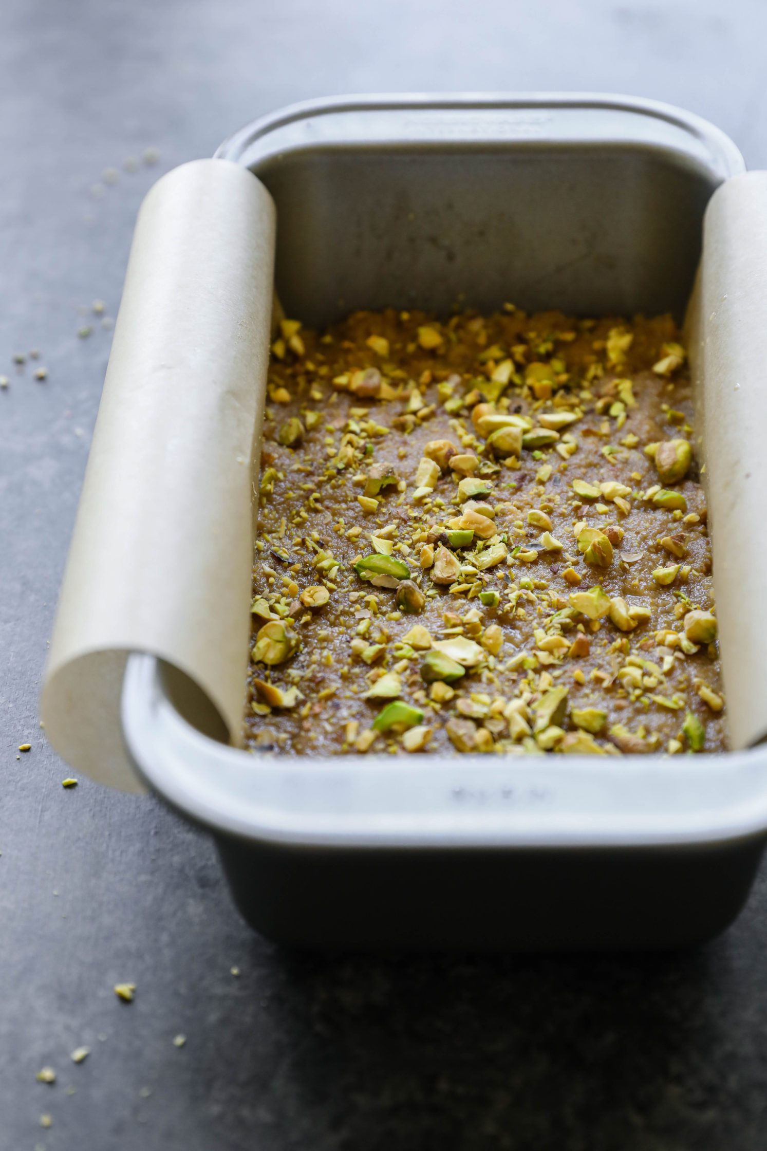 Vegan Tahini Date Halva in parchment lined bread pan by Flora & Vino