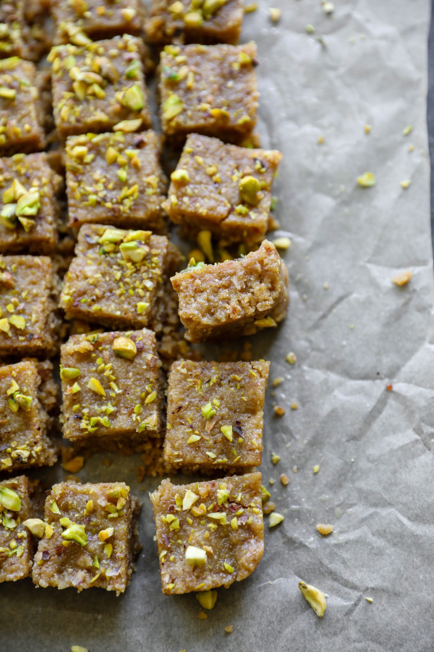 Vegan Tahini Date Halva sliced on parchment paper by Flora & Vino