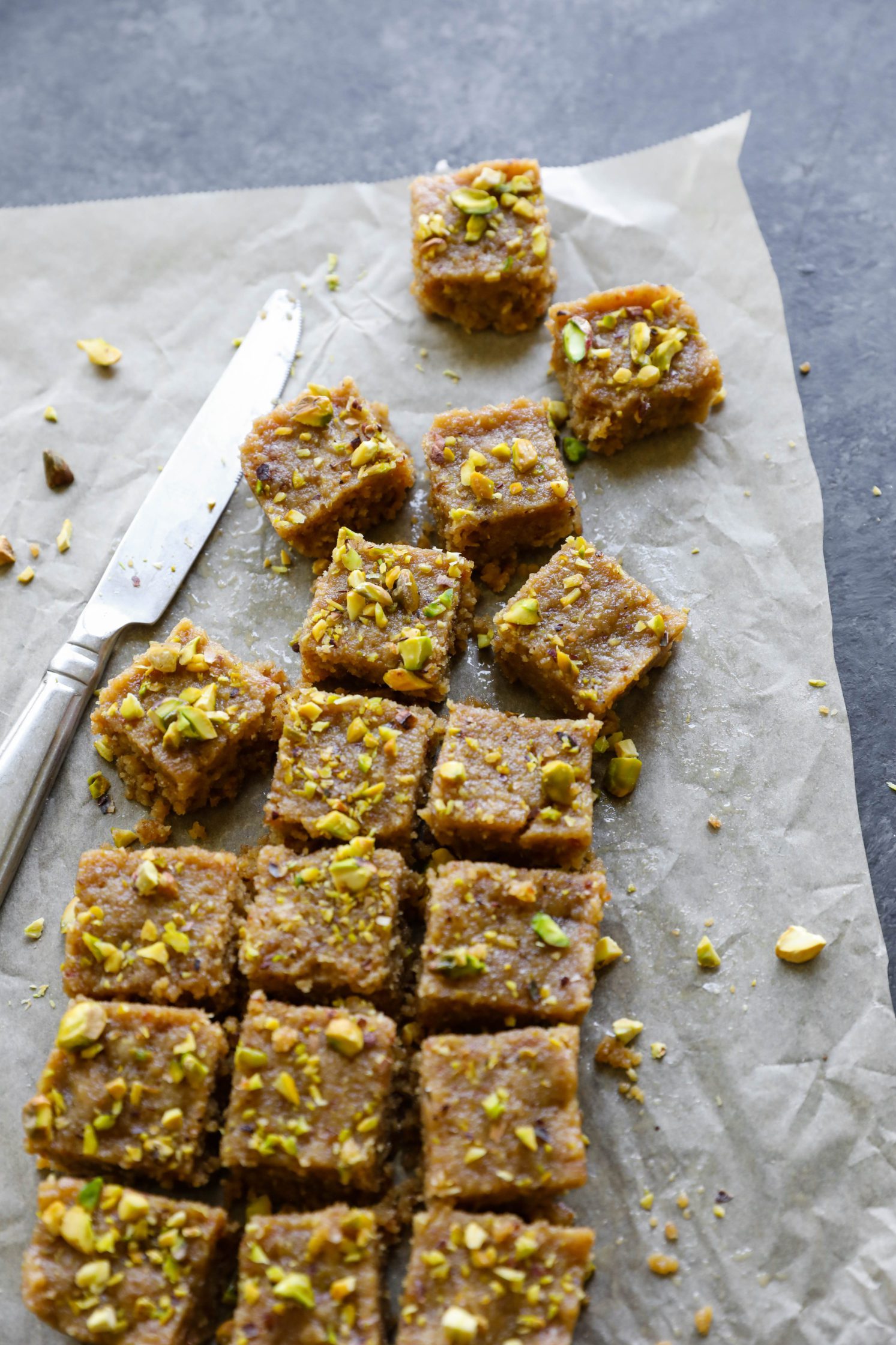 Vegan Tahini Date Halva sliced on parchment paper by Flora & Vino