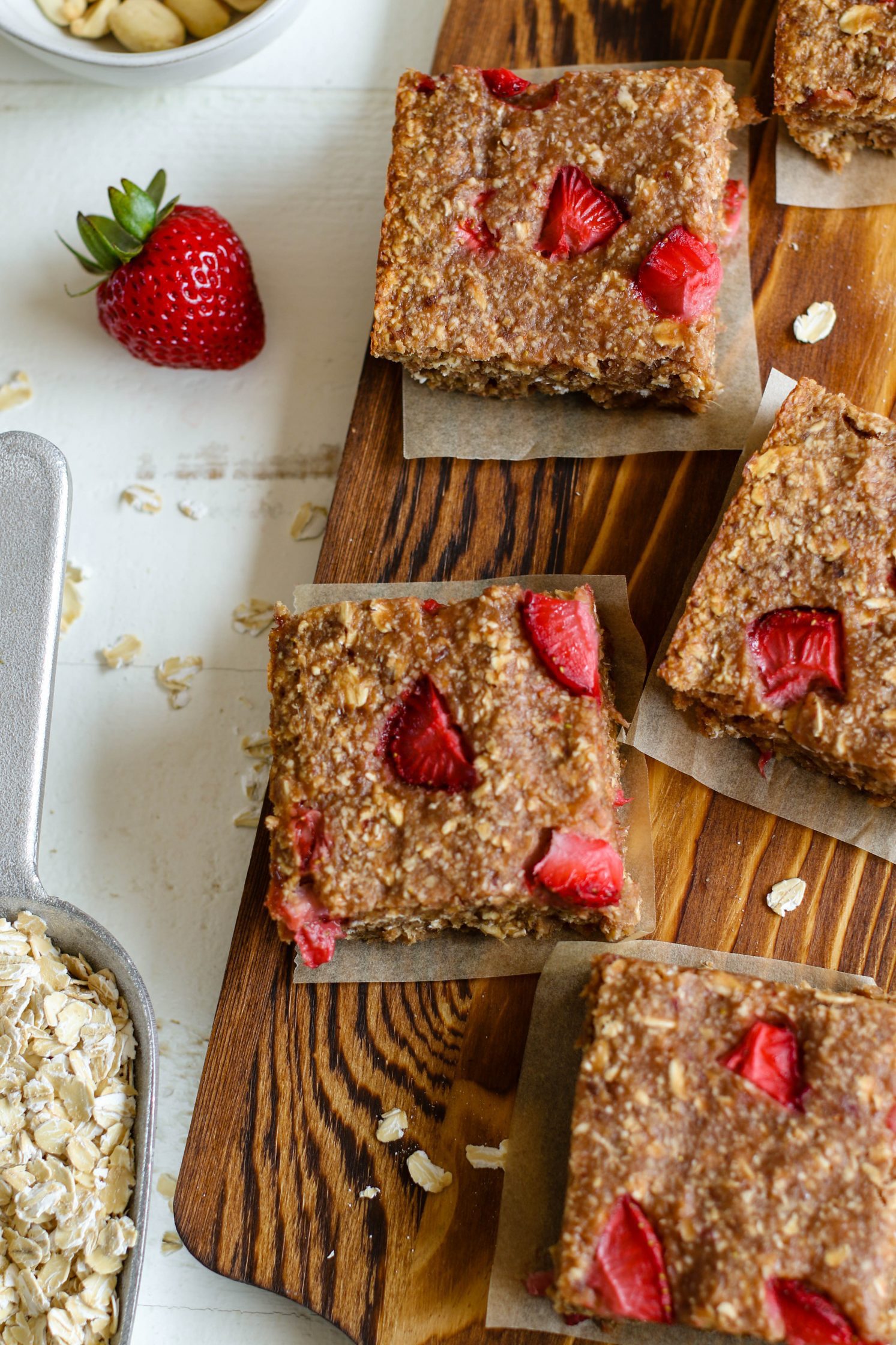 PB&J Baked Breakfast Bars cut into bars on wooden board by Flora & Vino