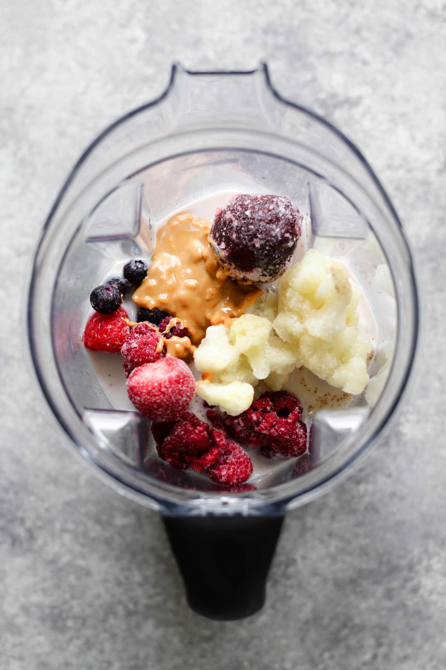 ingredients for peanut butter jelly and beet shake in blender