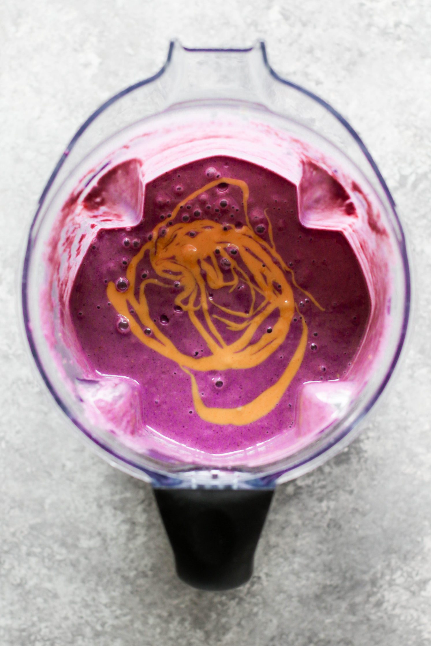 peanut butter jelly and beet shake blended in Vitamix blender topped with peanut butter drizzle