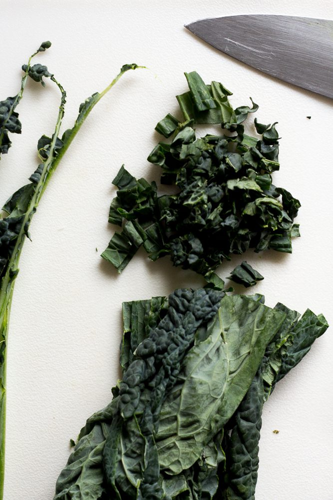 kale chopped on cutting board with knife