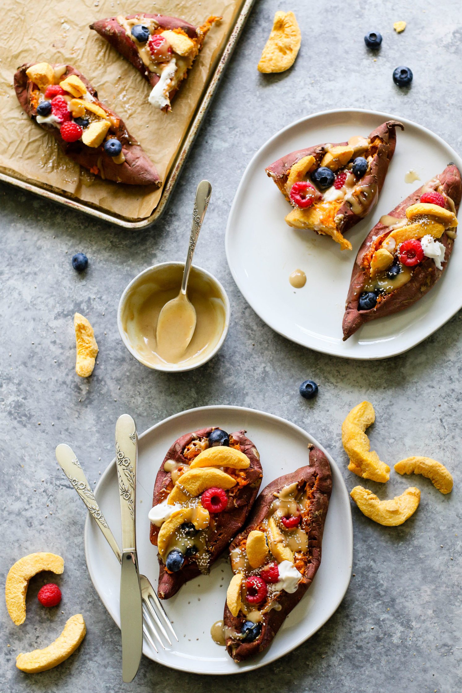 Stone Fruit Stuffed Sweet Potatoes served on plates topped with Maple Tahini